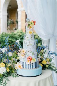 5 tier blue wedding cake with flower decor