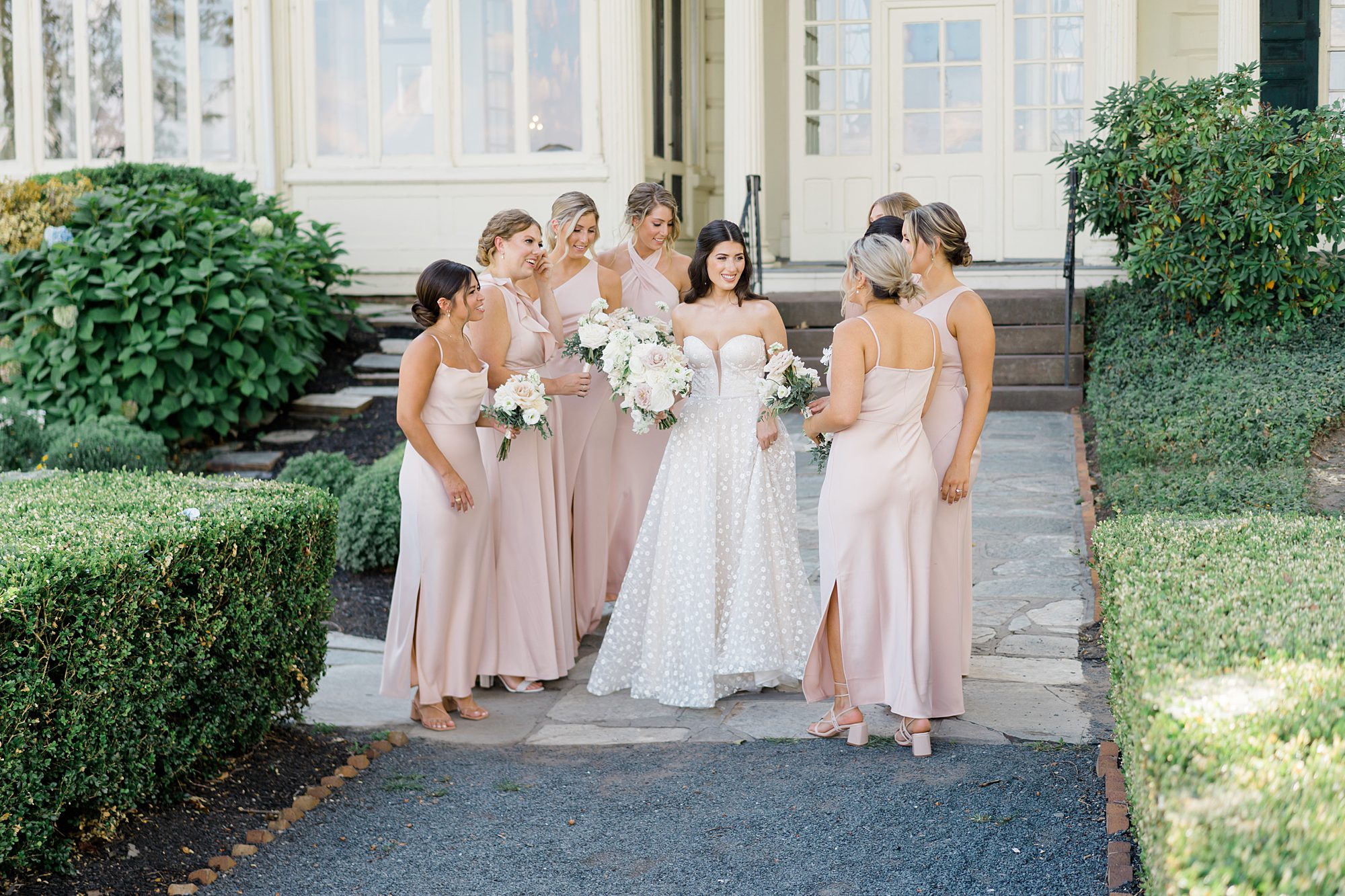 bride and bridesmaids on the steps of mansion at Glen Foerd on the Delaware