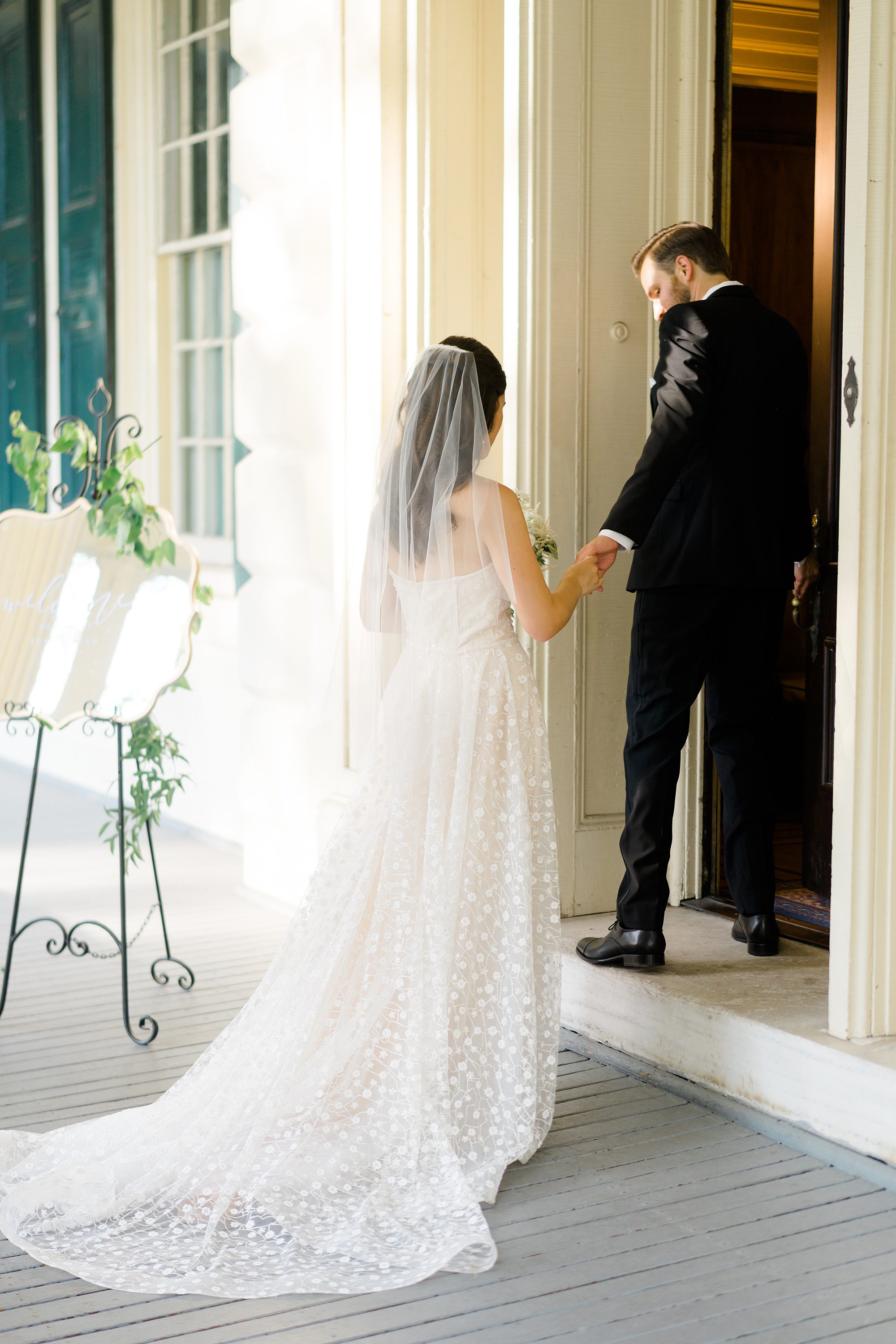 groom leads bride inside mansion at Glen Foerd on the Delaware