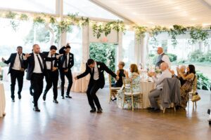 groomsmen enter wedding reception