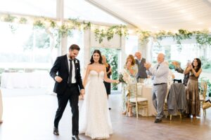 bride and groom make entrance to wedding reception