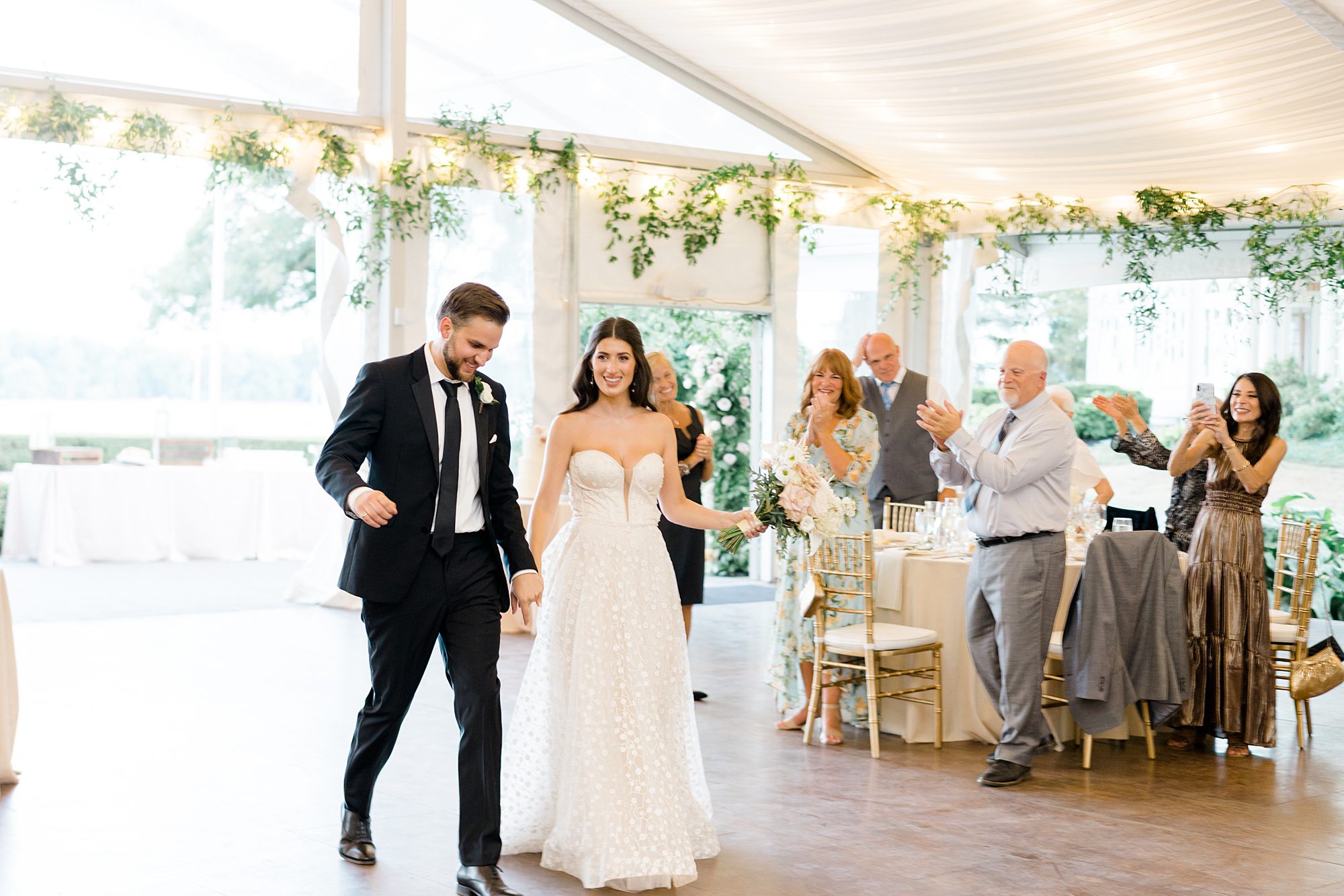 bride and groom make entrance to wedding reception