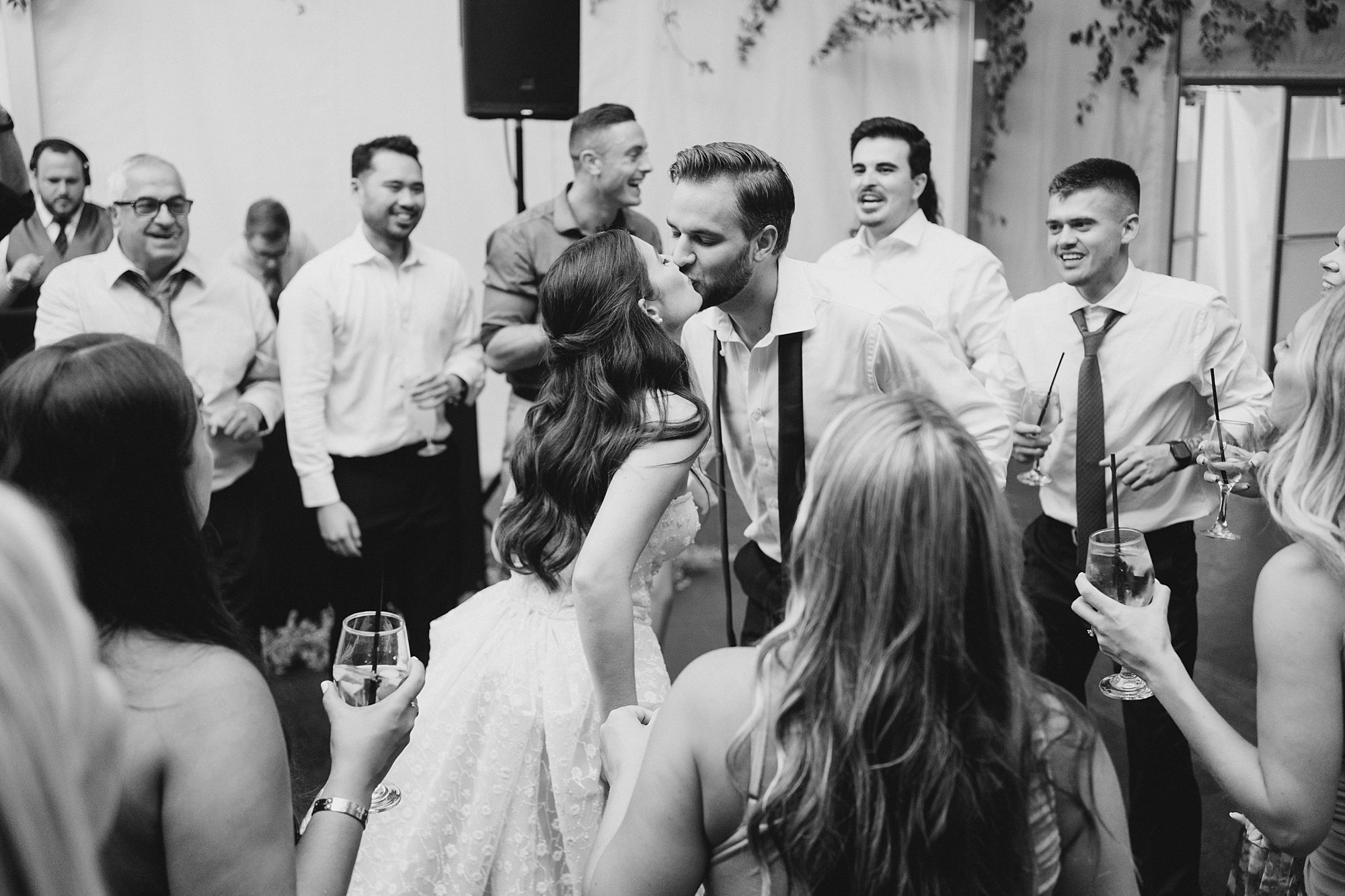 newlyweds dance with guests at reception