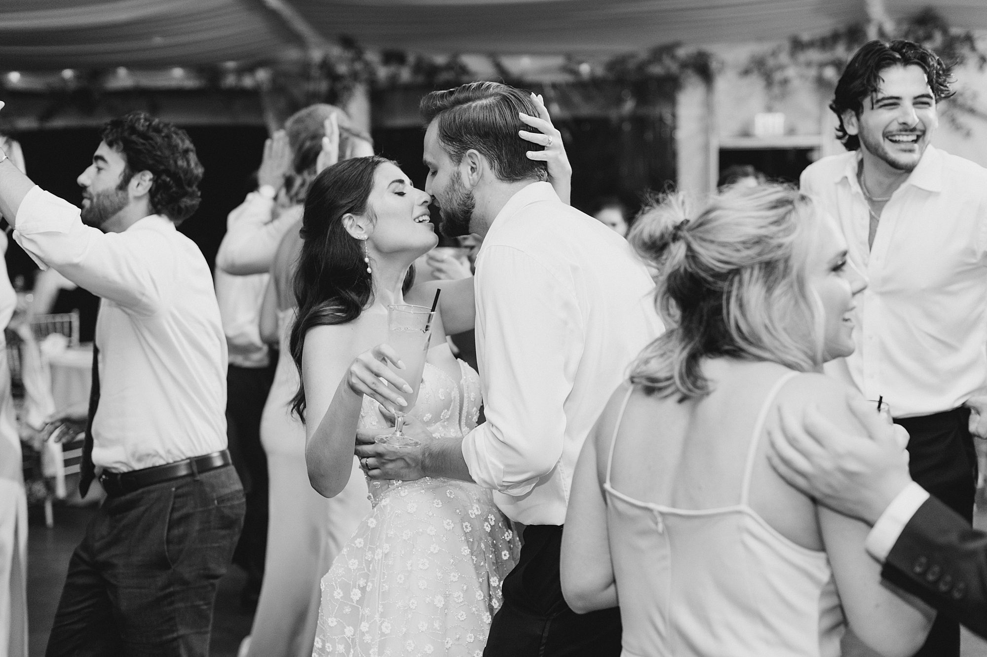 bride and groom kiss on the dance floor
