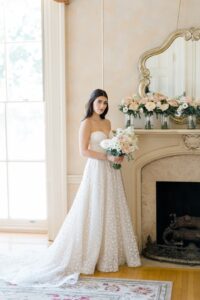 bride standing by mantel