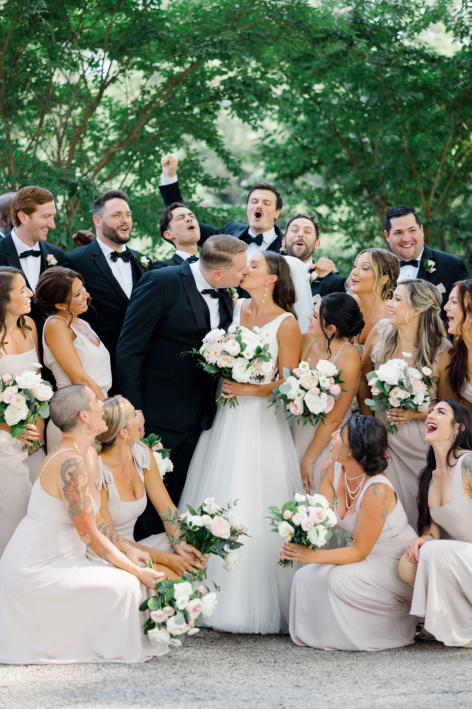bridal party cheer and bride and groom kiss