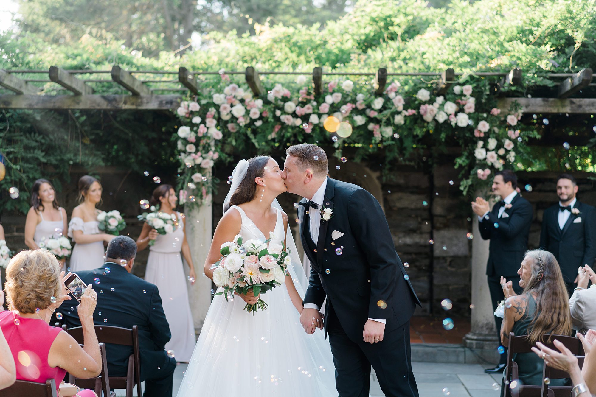 bride and groom kiss during Garden Wedding at Curtis Arboretum