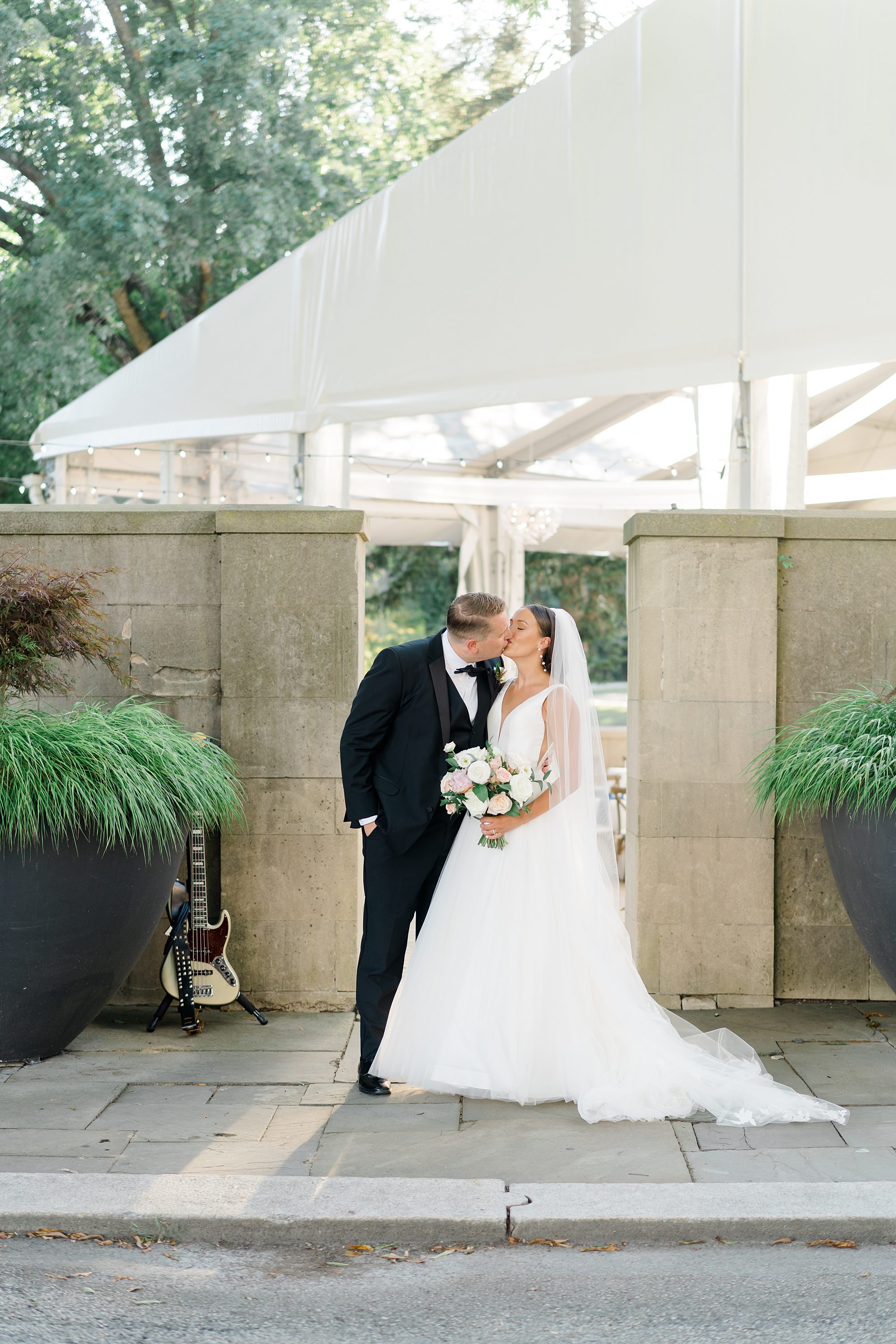 newlyweds kiss after Garden Wedding at Curtis Arboretum