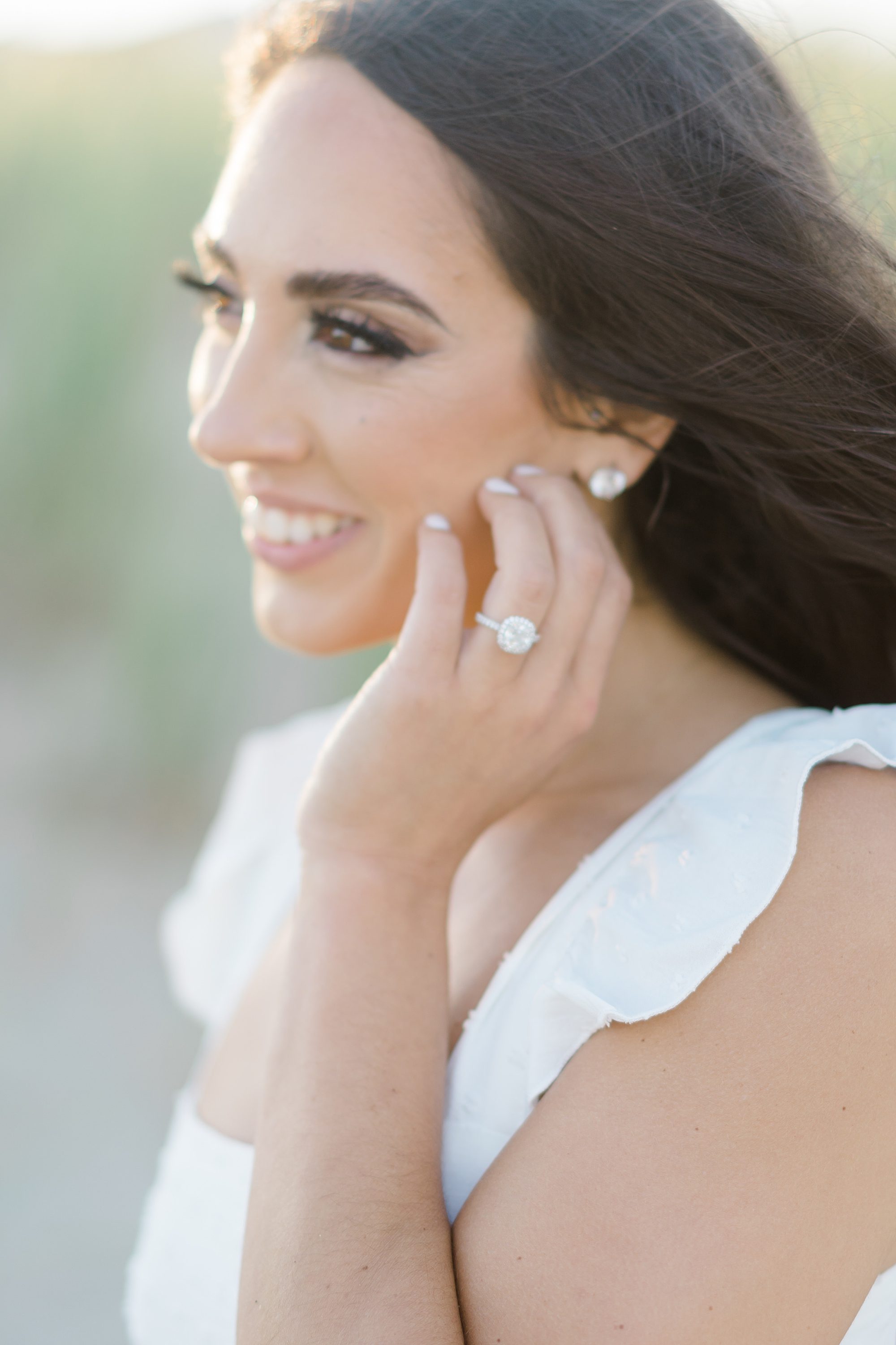 woman shows off engagement ring during engagement session