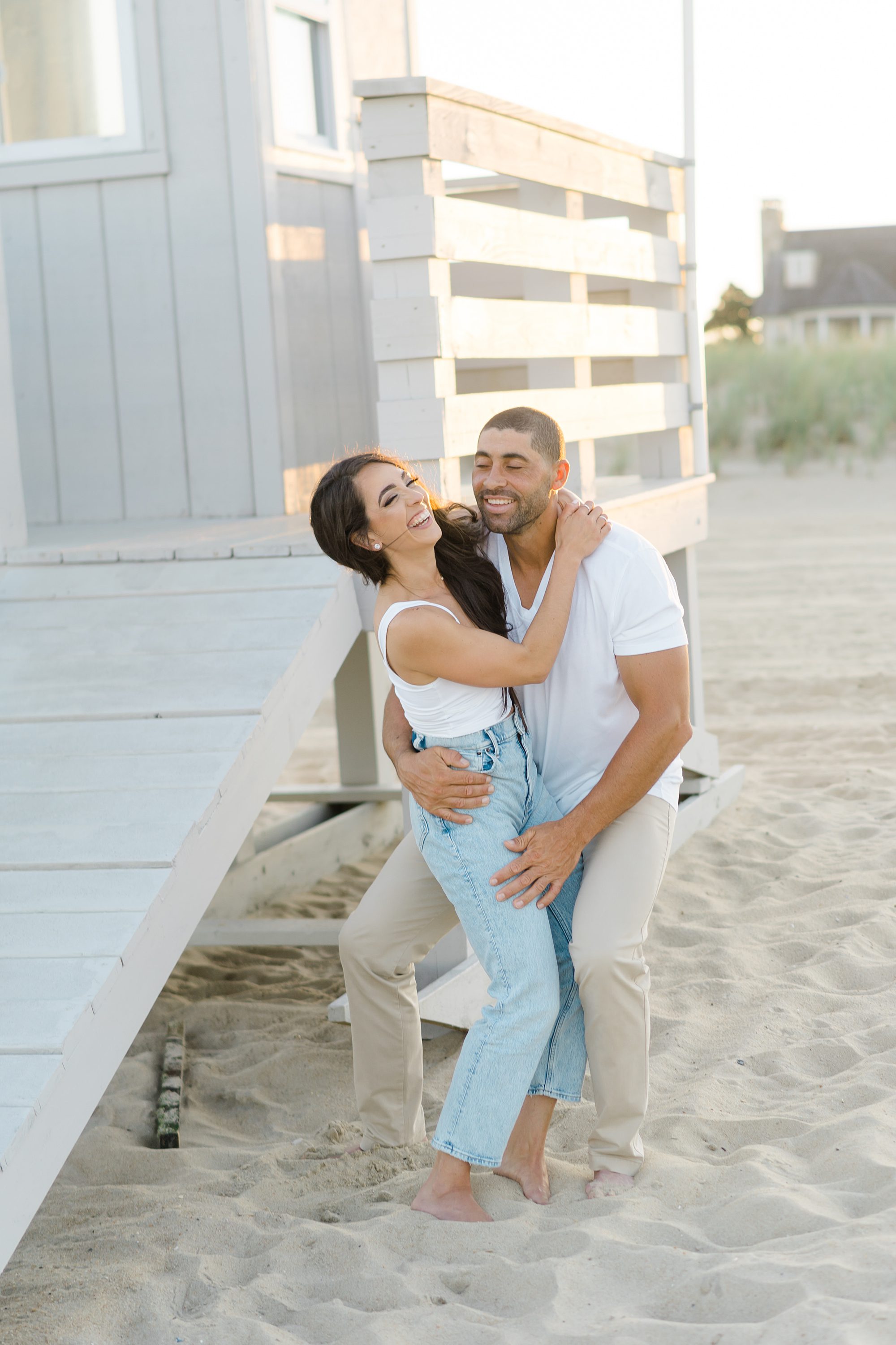 candid moment of couple laughing on the beach