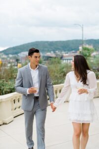 couple walk on the balcony of Wilbur Mansion for engagement session