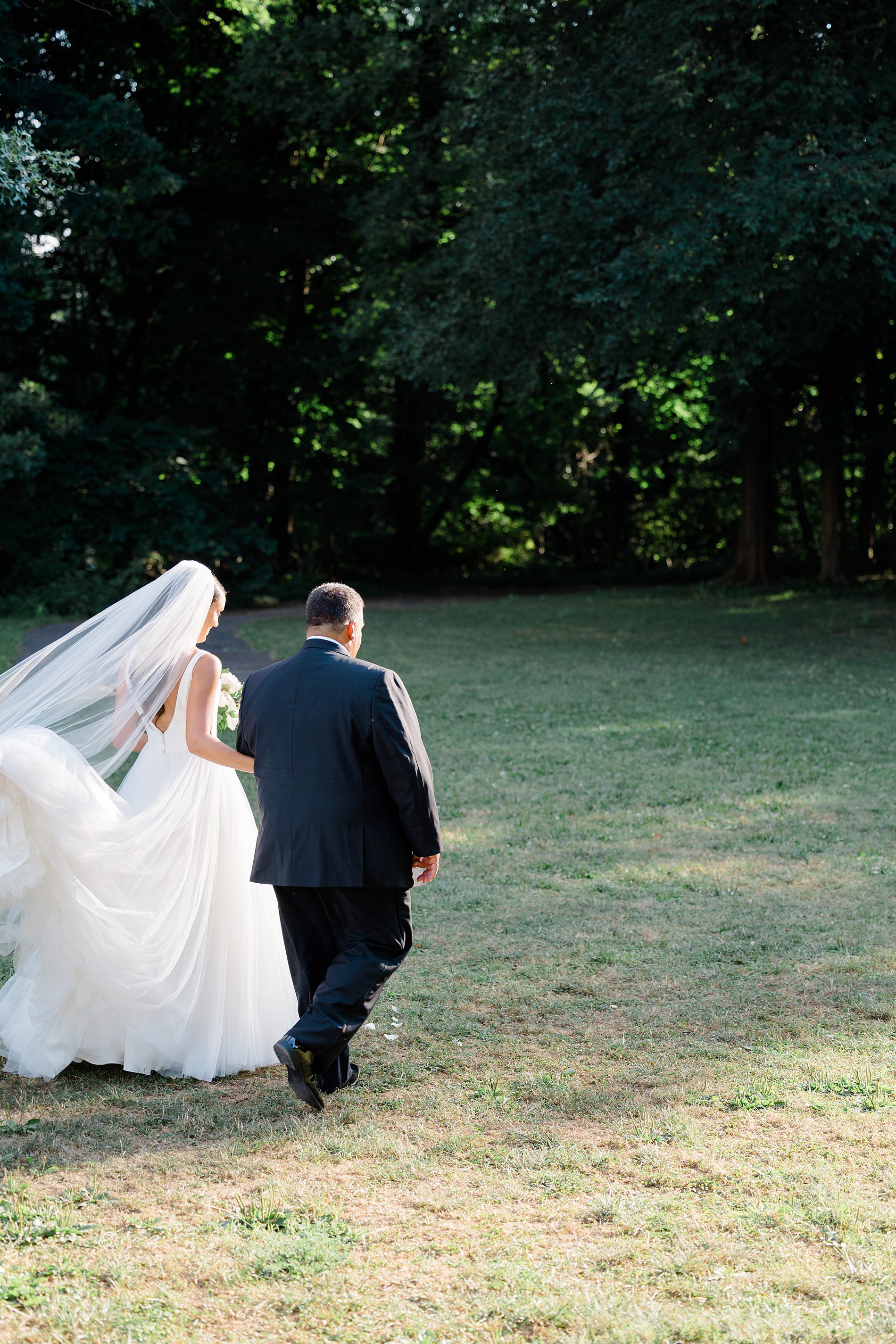 bride and dad walk down the aisle at Curtis Arboretum Wedding
