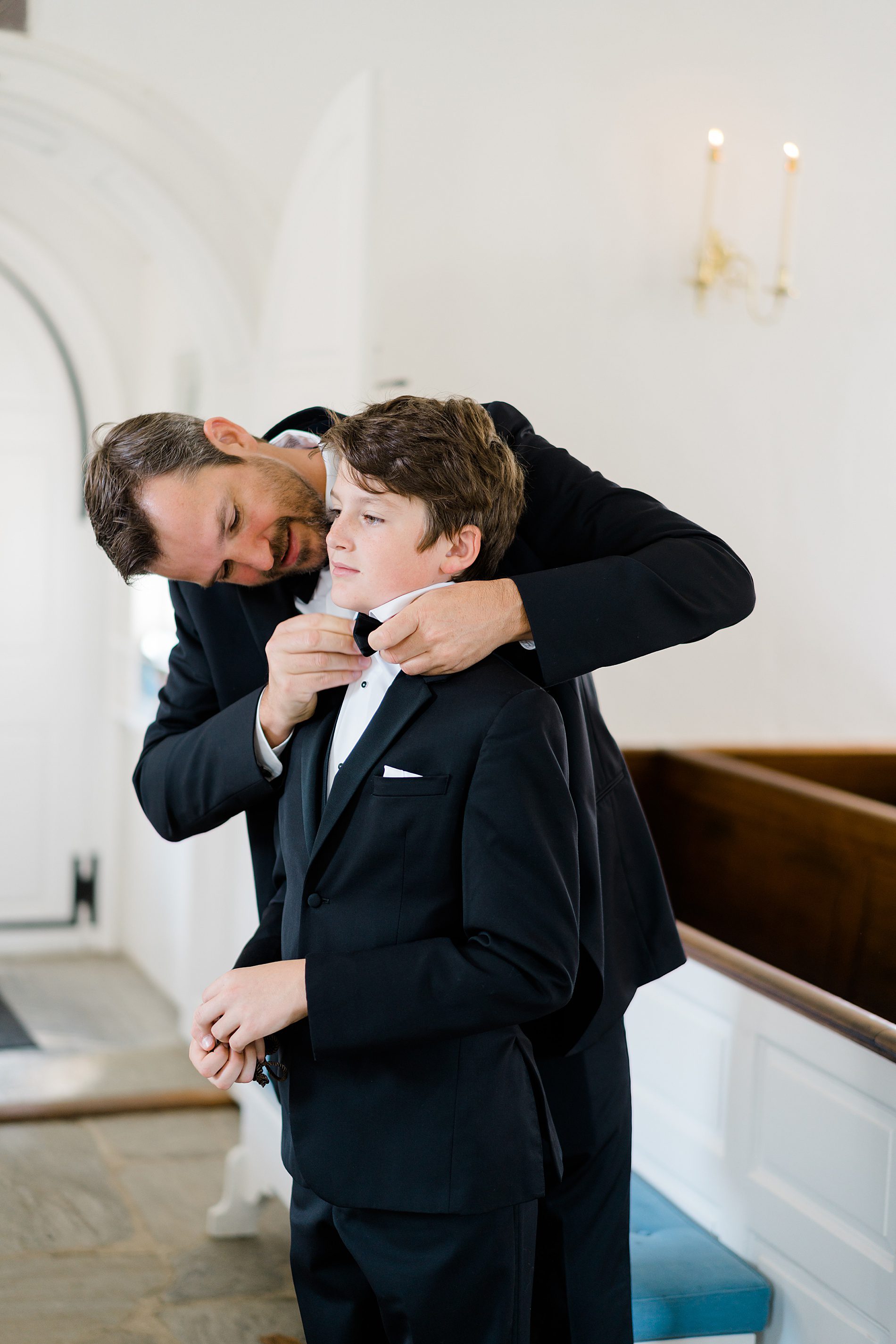 groom helping his son with bowtie