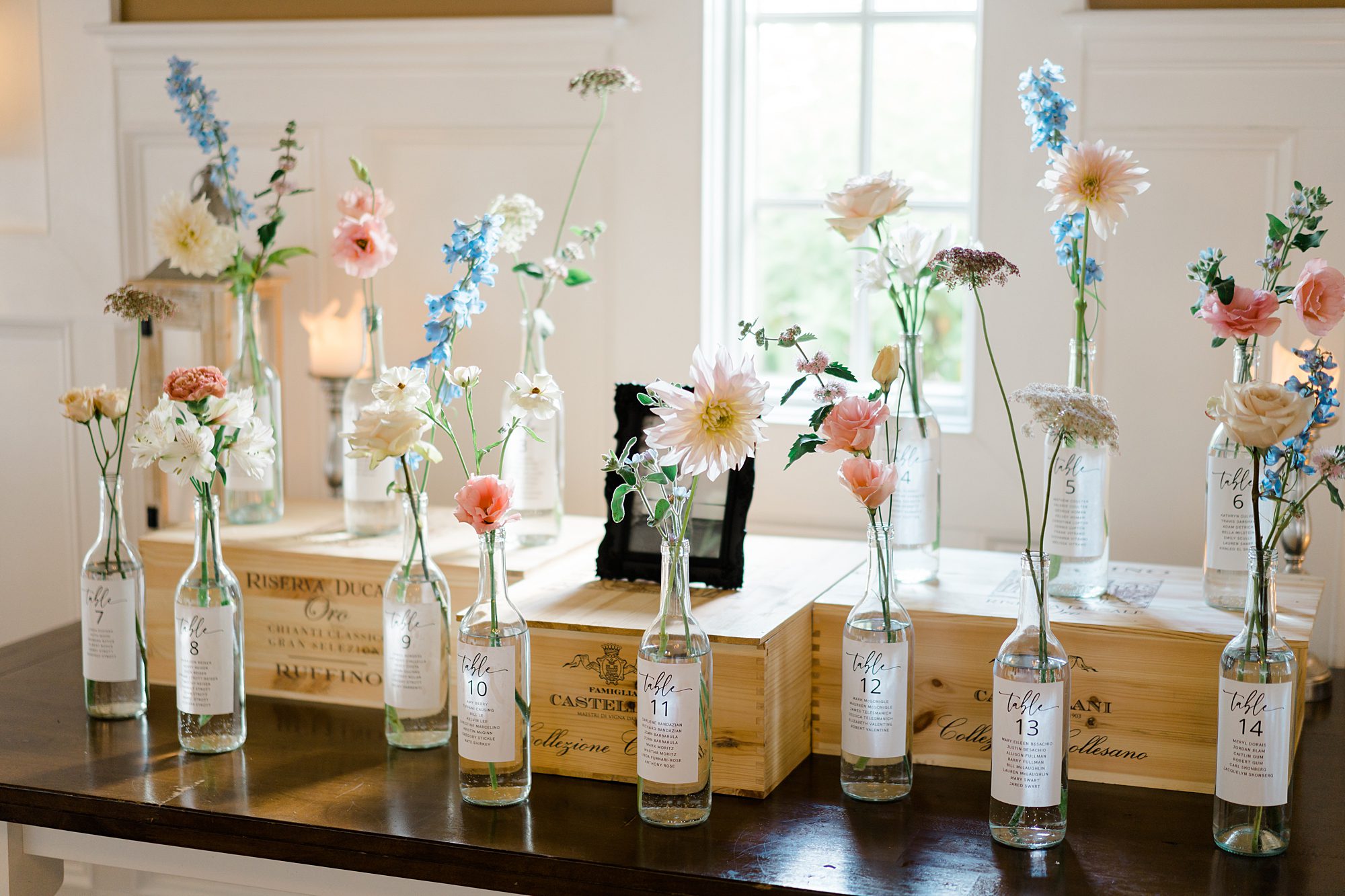table identifiers with flowers in bottles