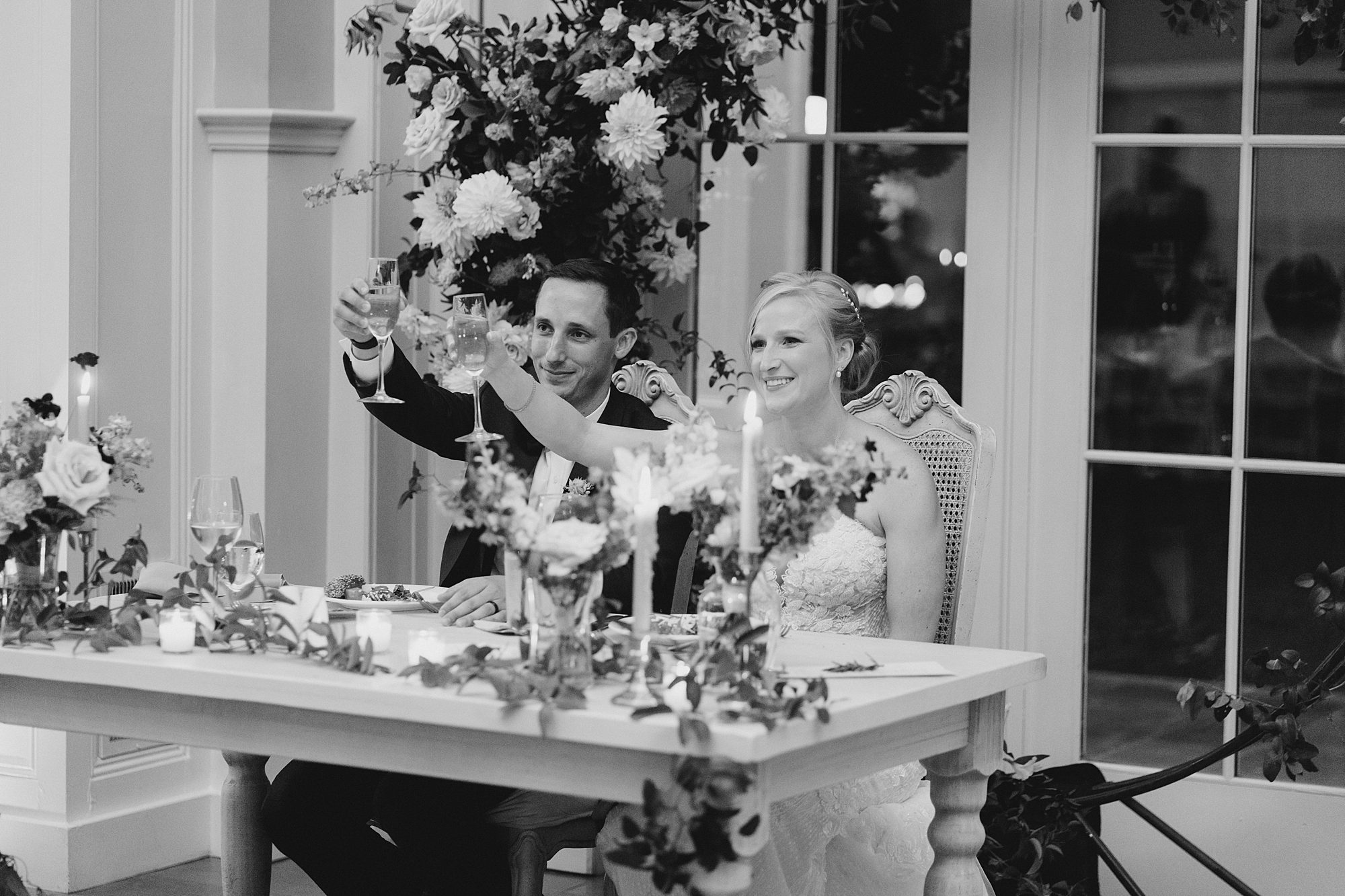 newlyweds toasting at wedding reception