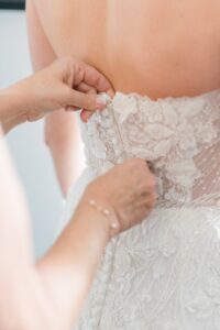 bride gets into her wedding dress