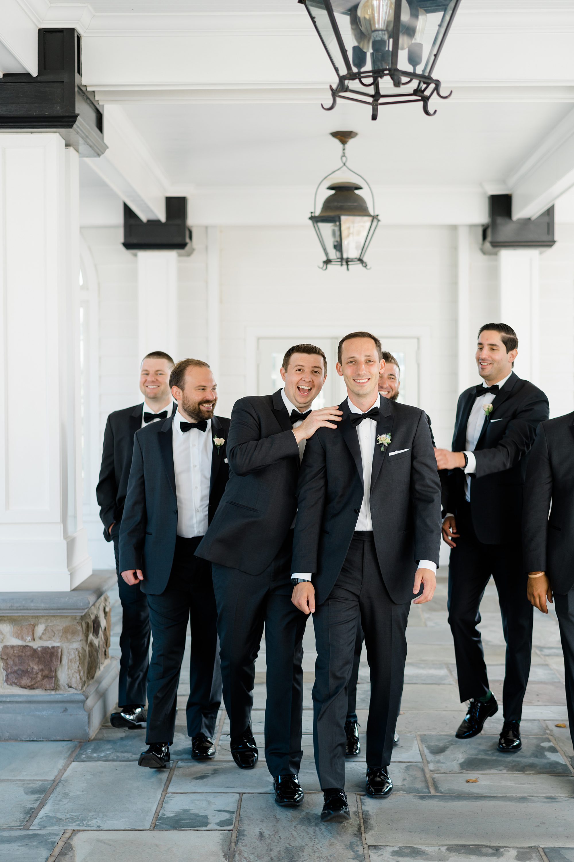 groom and groomsmen before elegant garden inspired wedding at the Ryland Inn