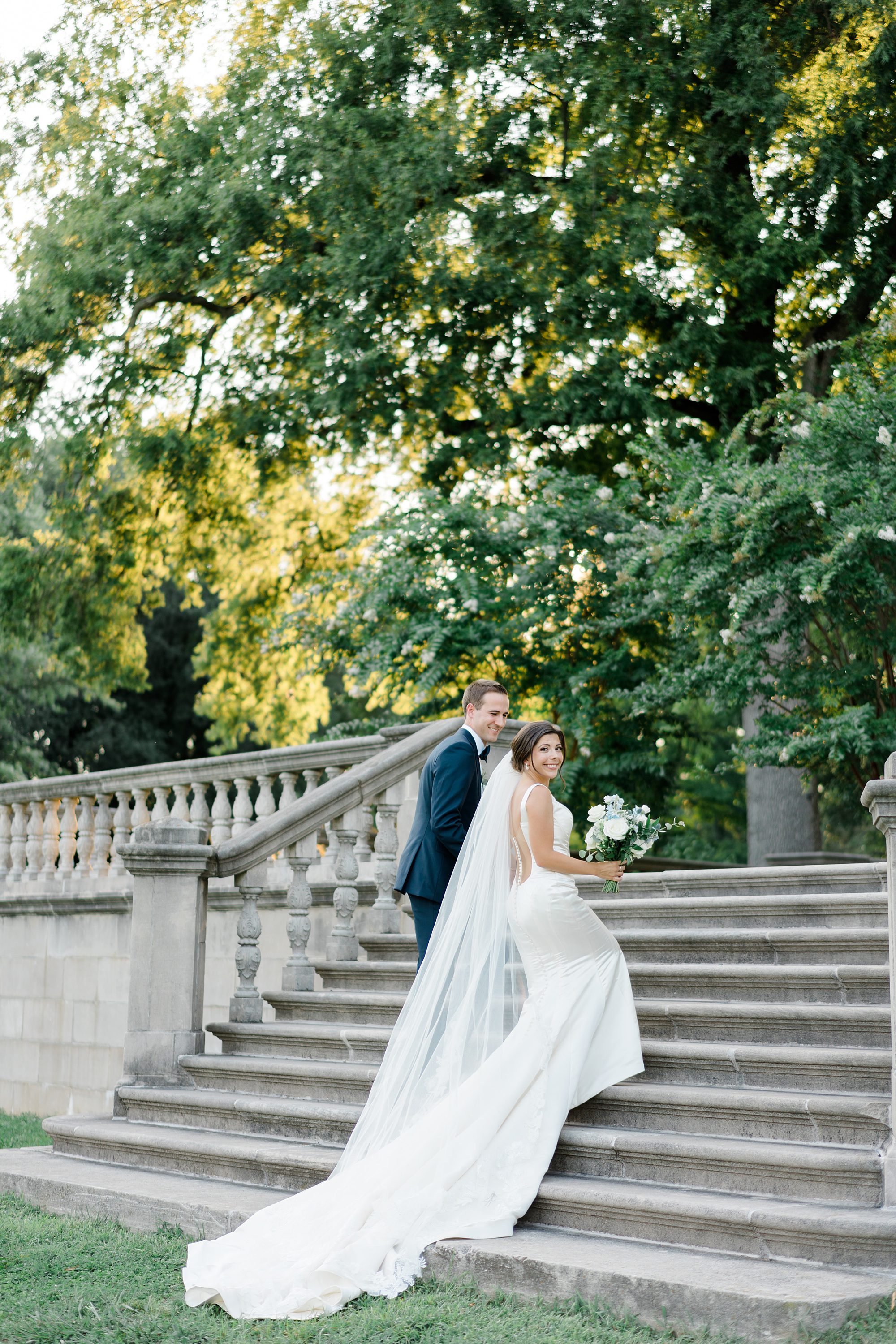 newlyweds walk up stairs of Curtis Arboretum