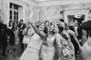 women take selfie at wedding reception