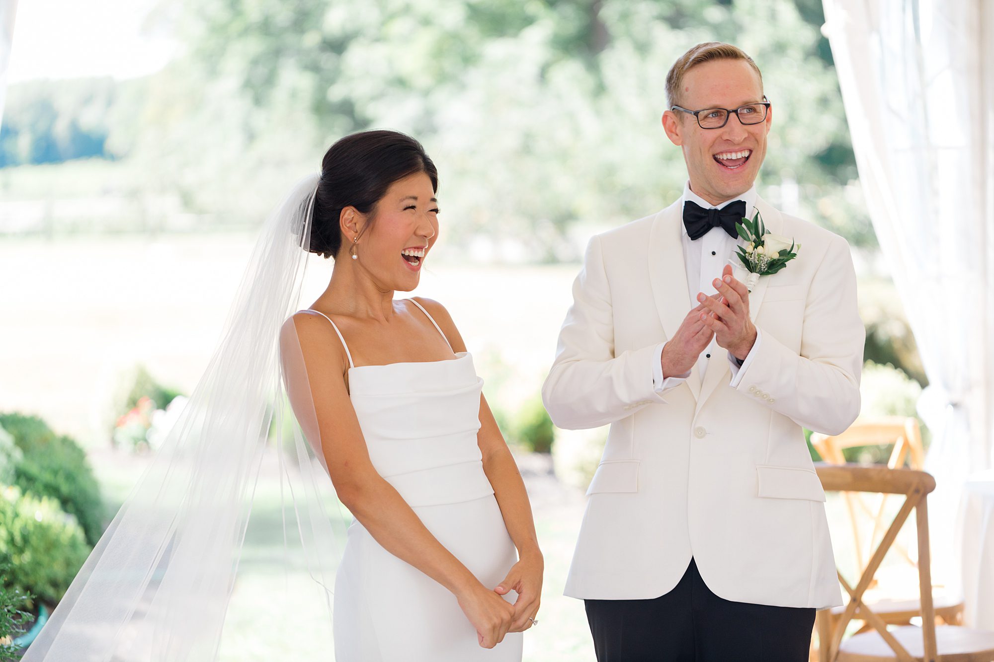 couple share a laugh together at wedding reception