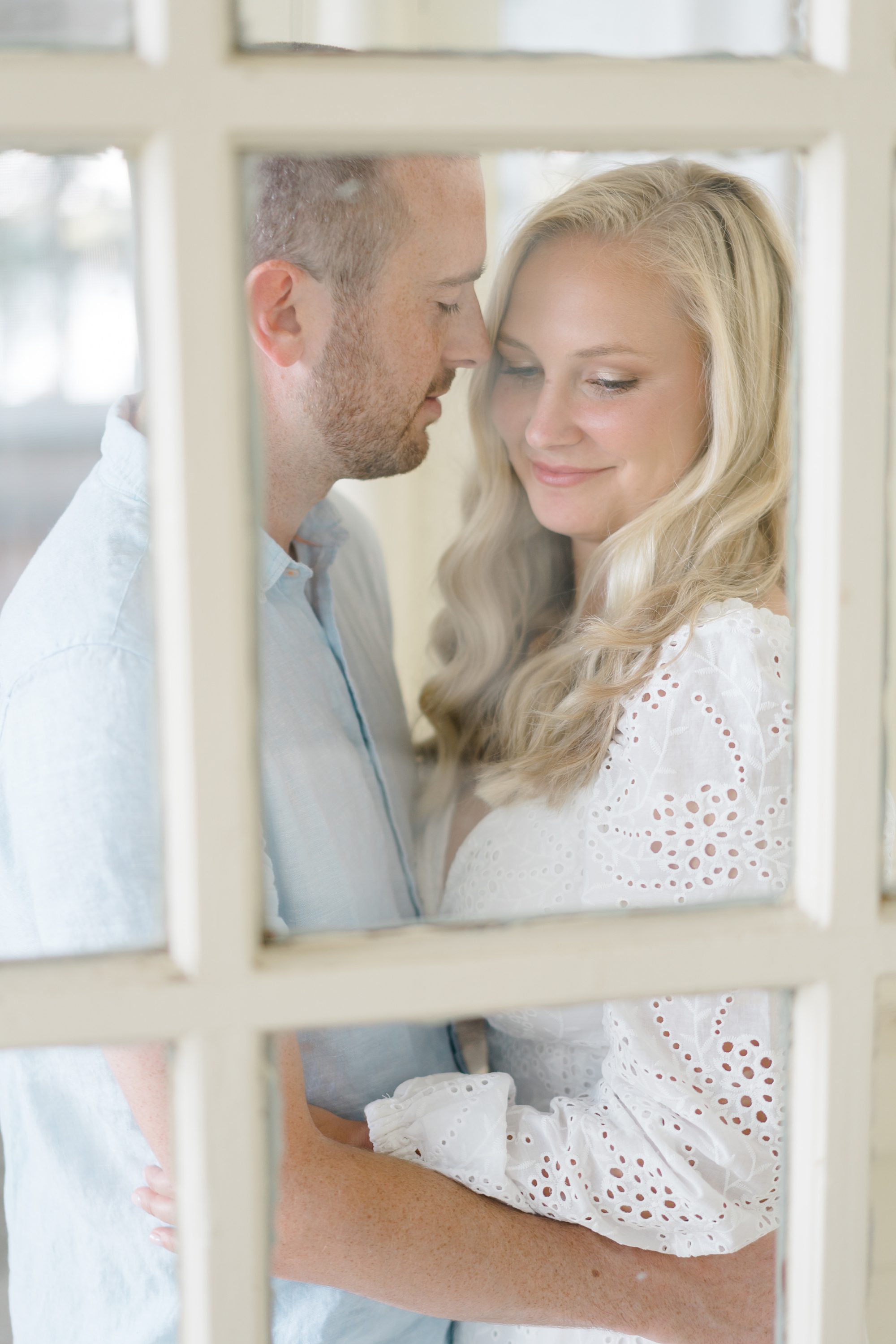 engaged couple inside the window of Glen Foerd