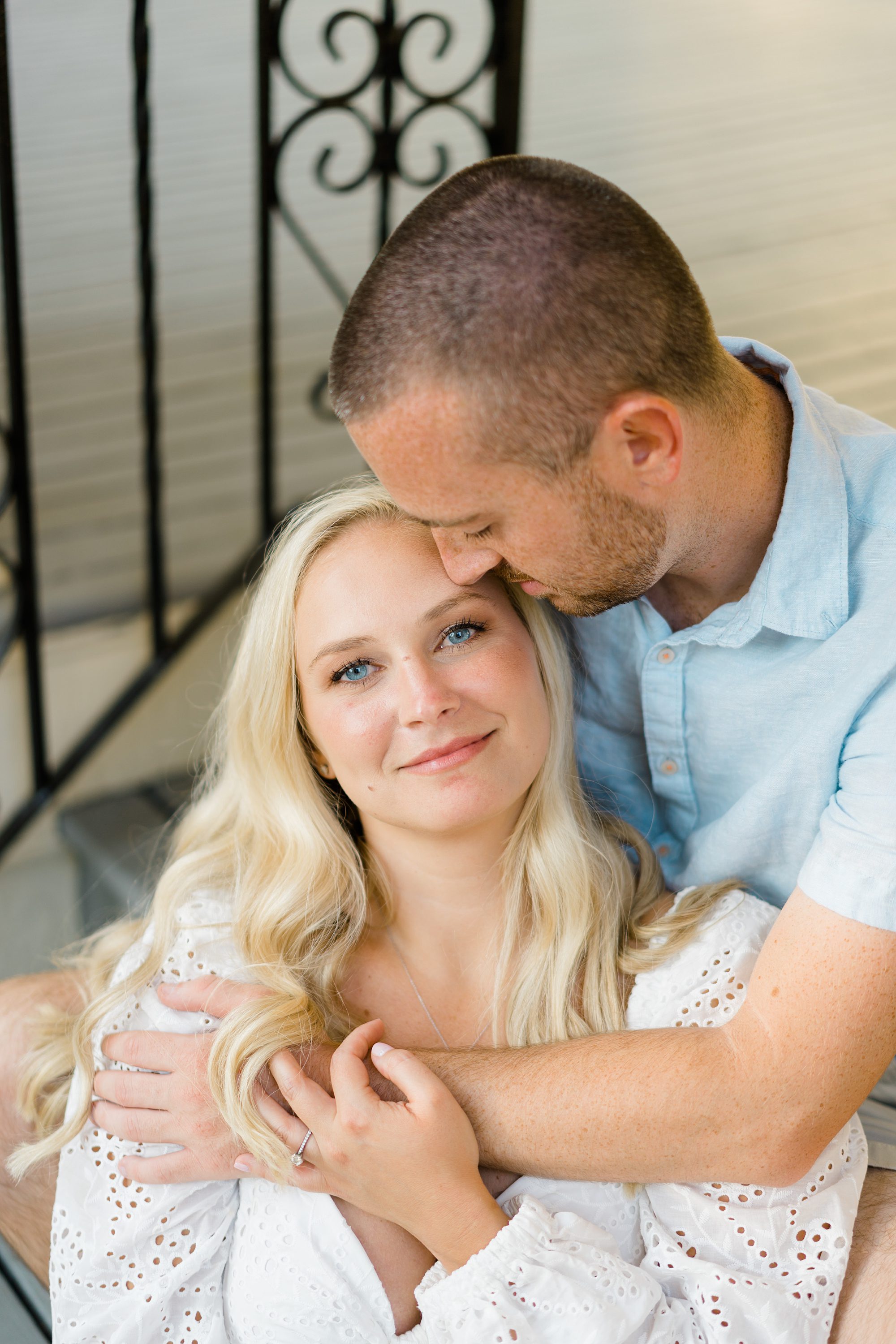 man kisses fiance during engagement portraits