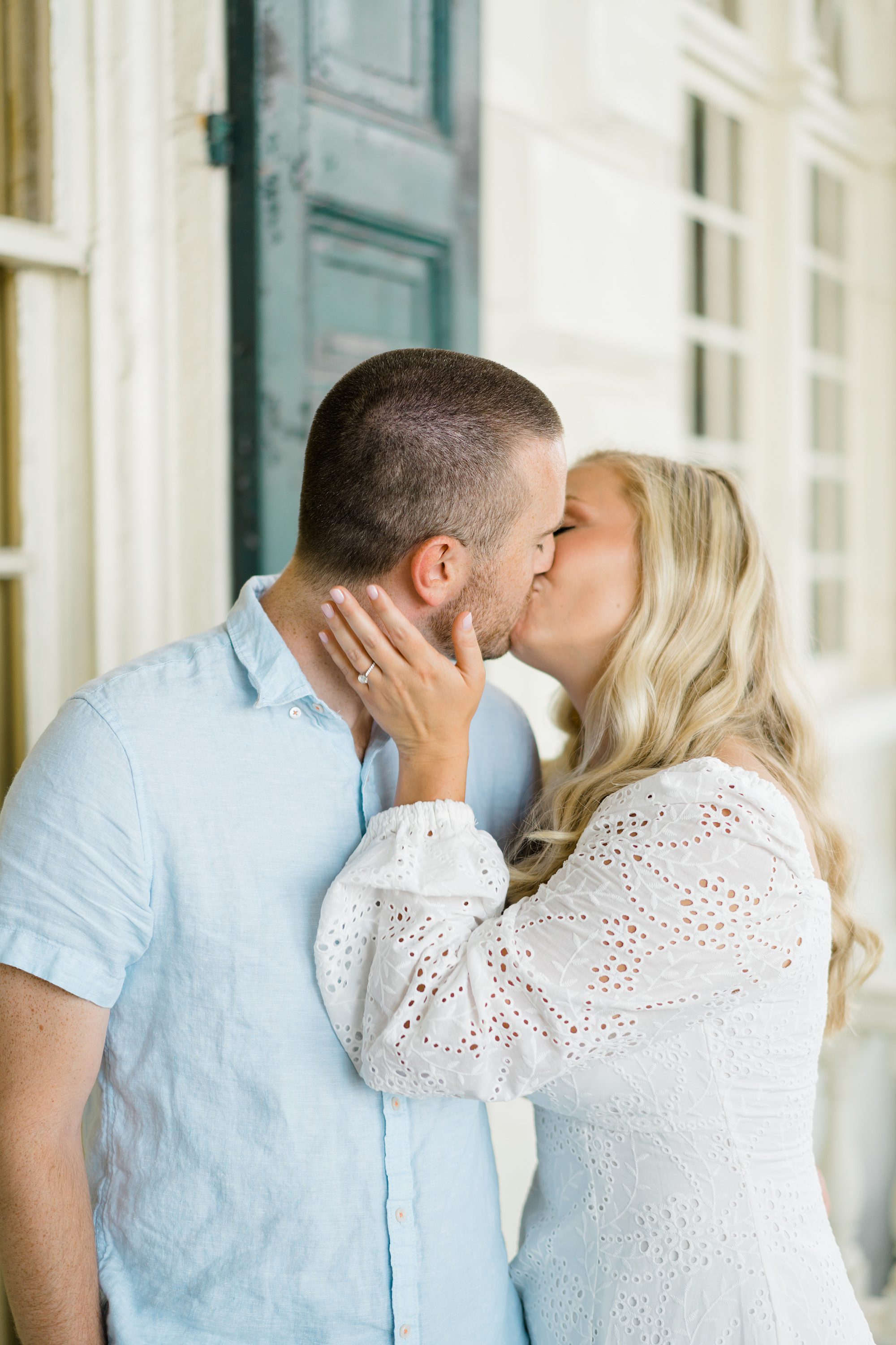 couple kiss on porch at Glen Foerd on the Delaware in Philadelphia