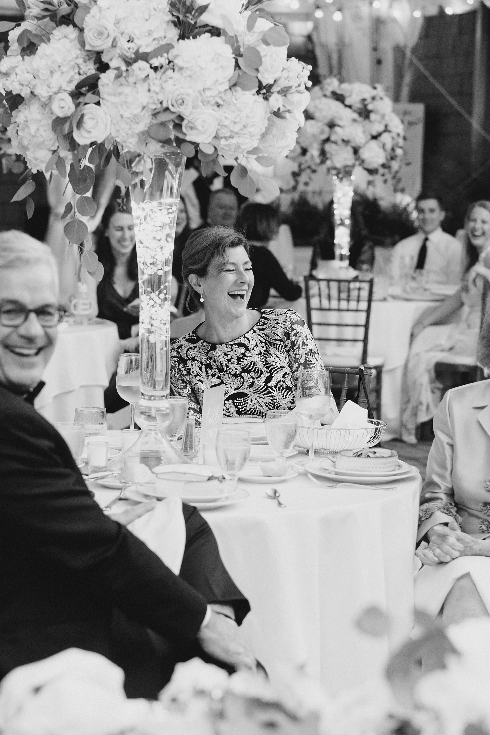 wedding guests laugh during speeches