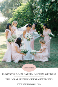 Bridesmaids in dusty pink dresses surround bride