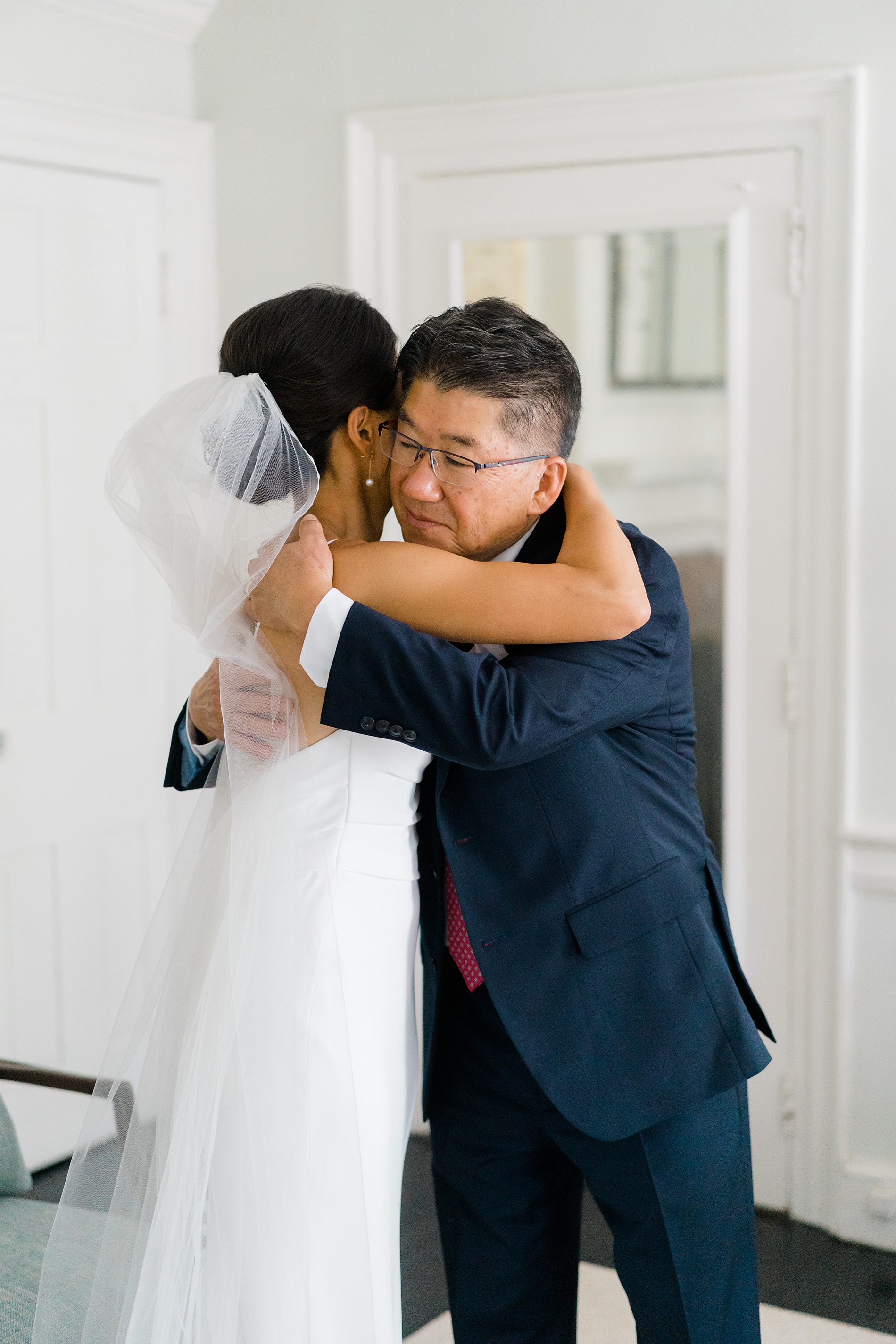 bride hugs her dad during first look