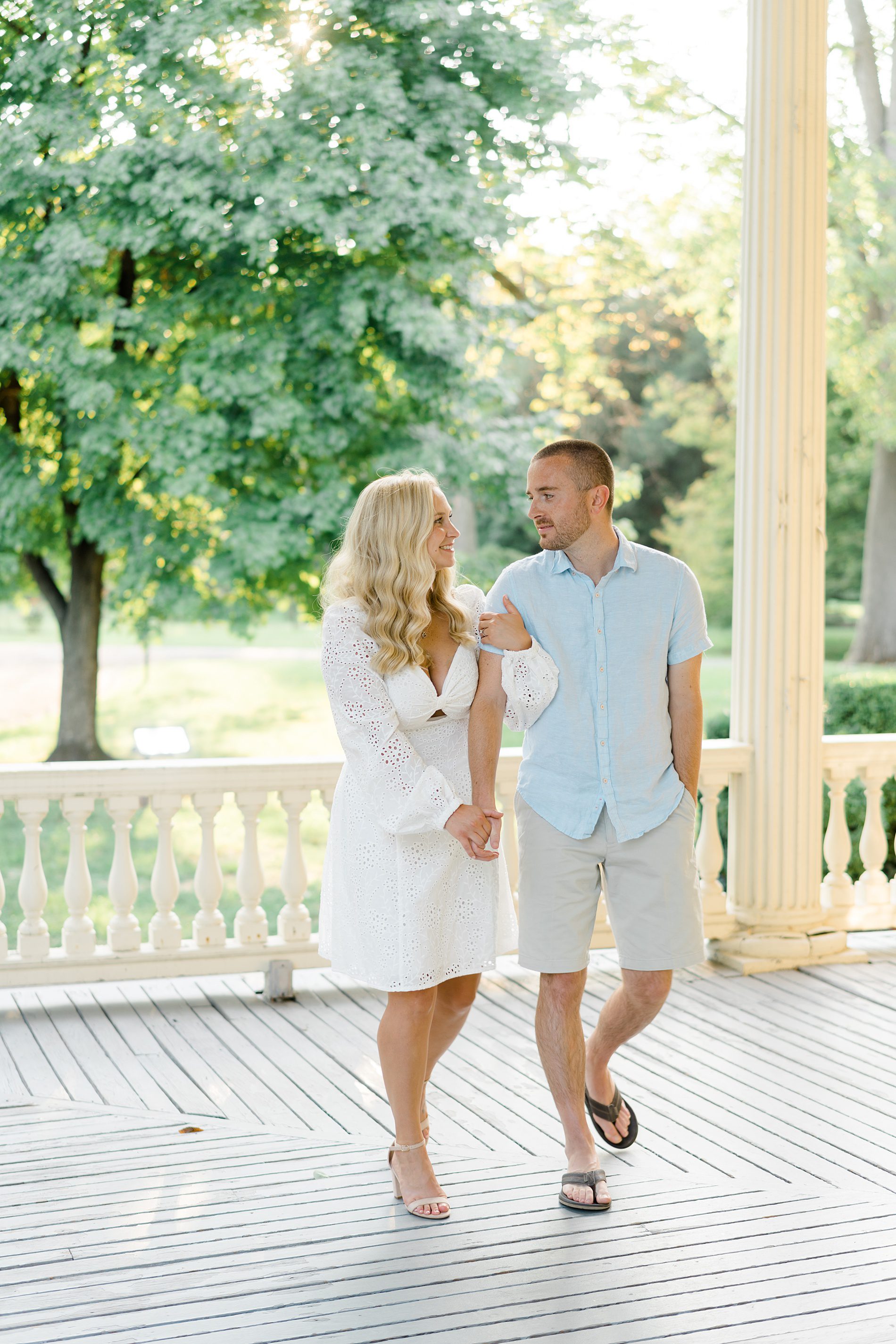 Engaged couple walk on the porch of Philadelphia wedding venue