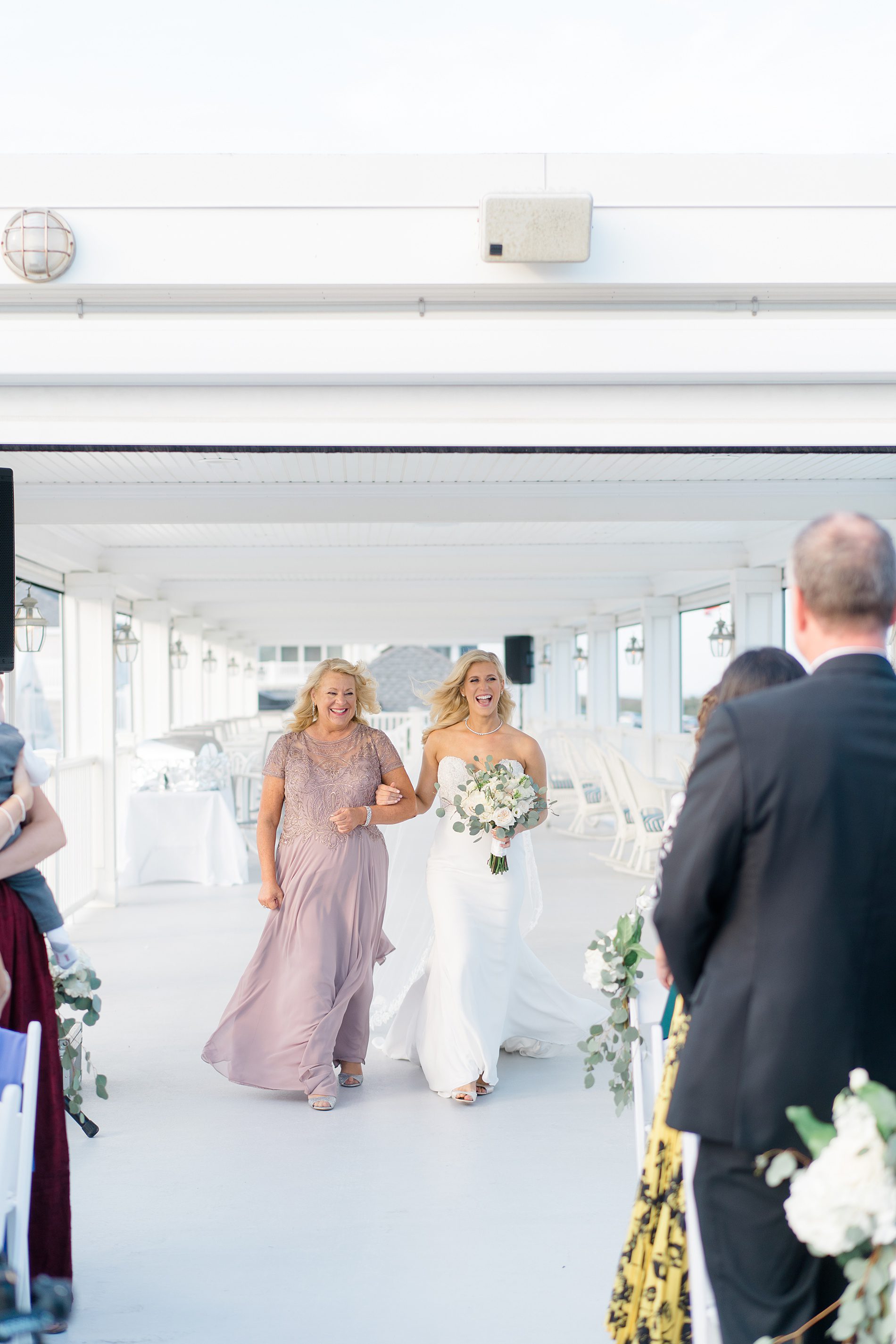 bride walks down the aisle towards groom