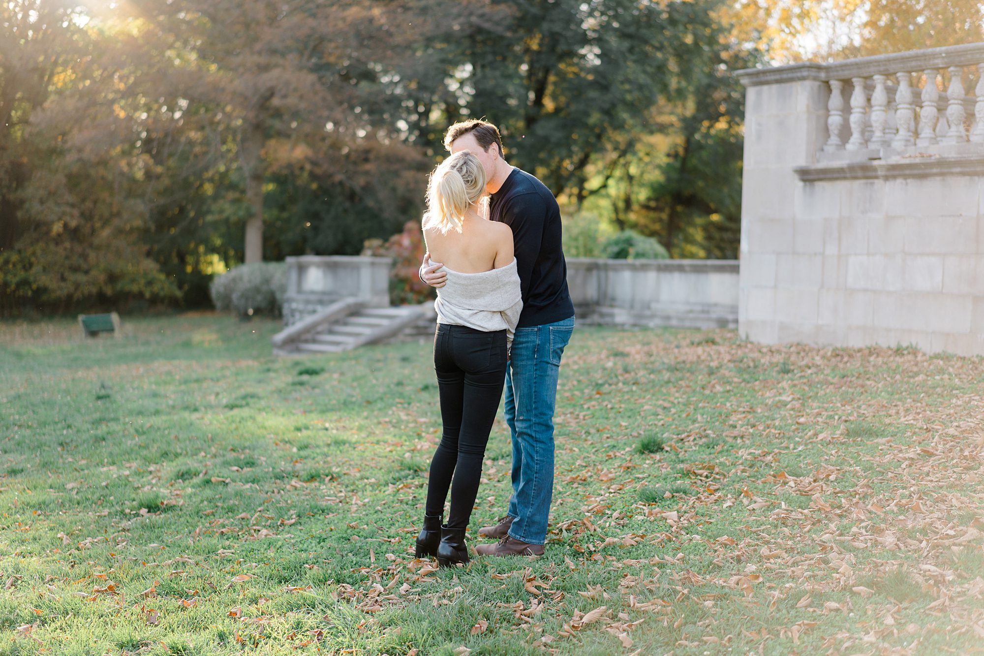 couple kiss on the grounds of Curtis Arboretum