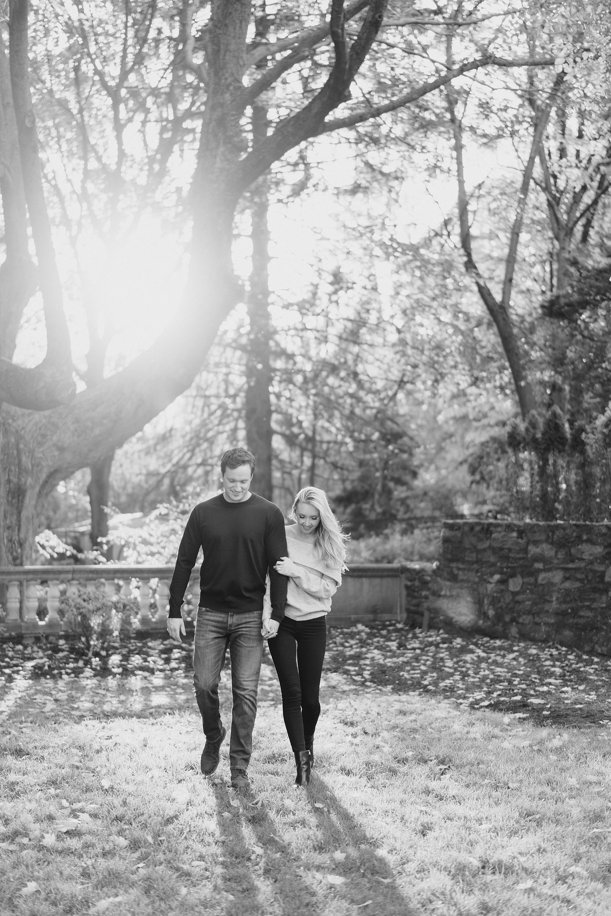engaged couple walk together during Fall Engagement at Curtis Arboretum