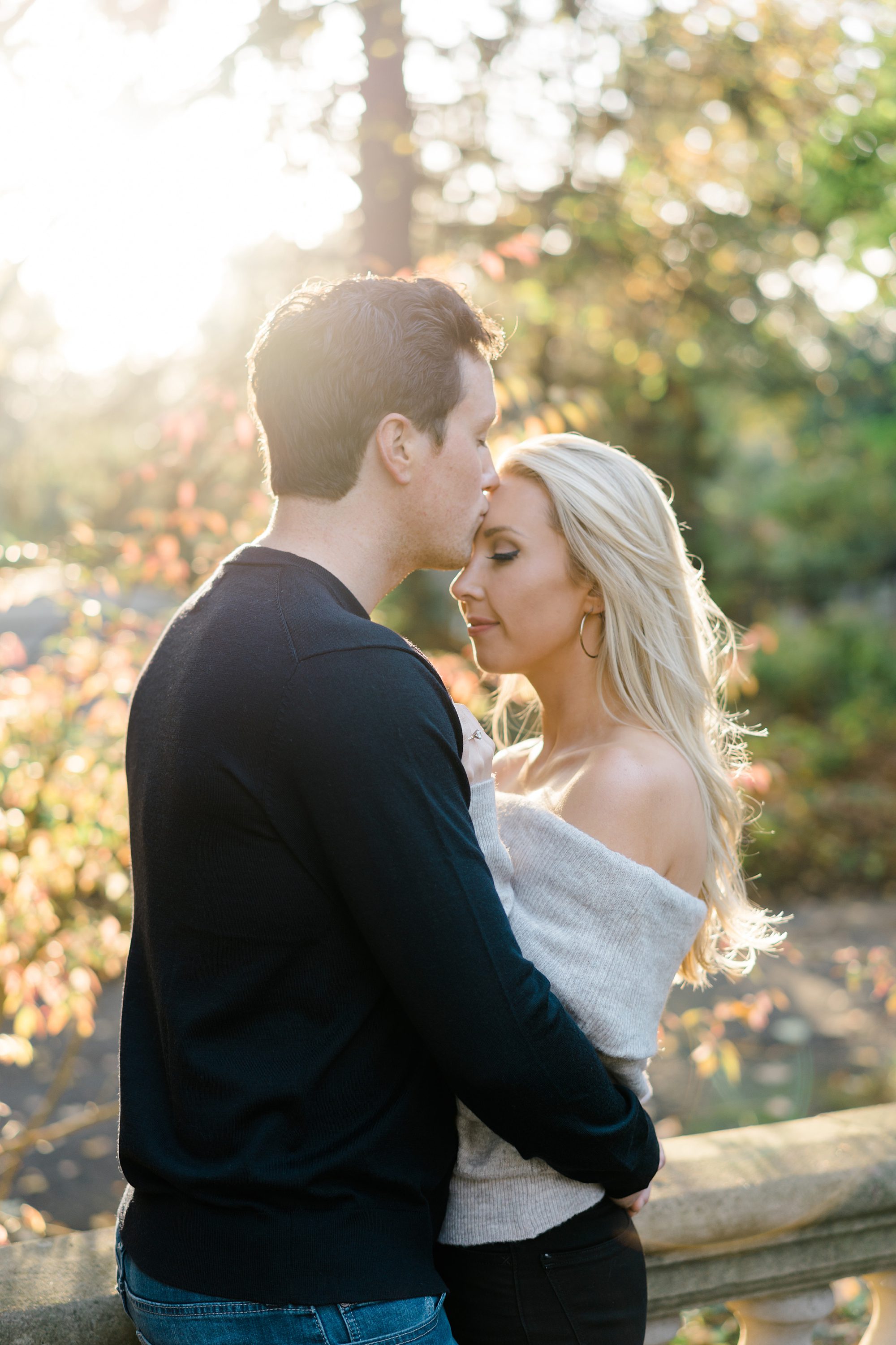 man kisses his fiance's head during light and airy engagement session by Philadelphia photographer Amber Dawn Photography