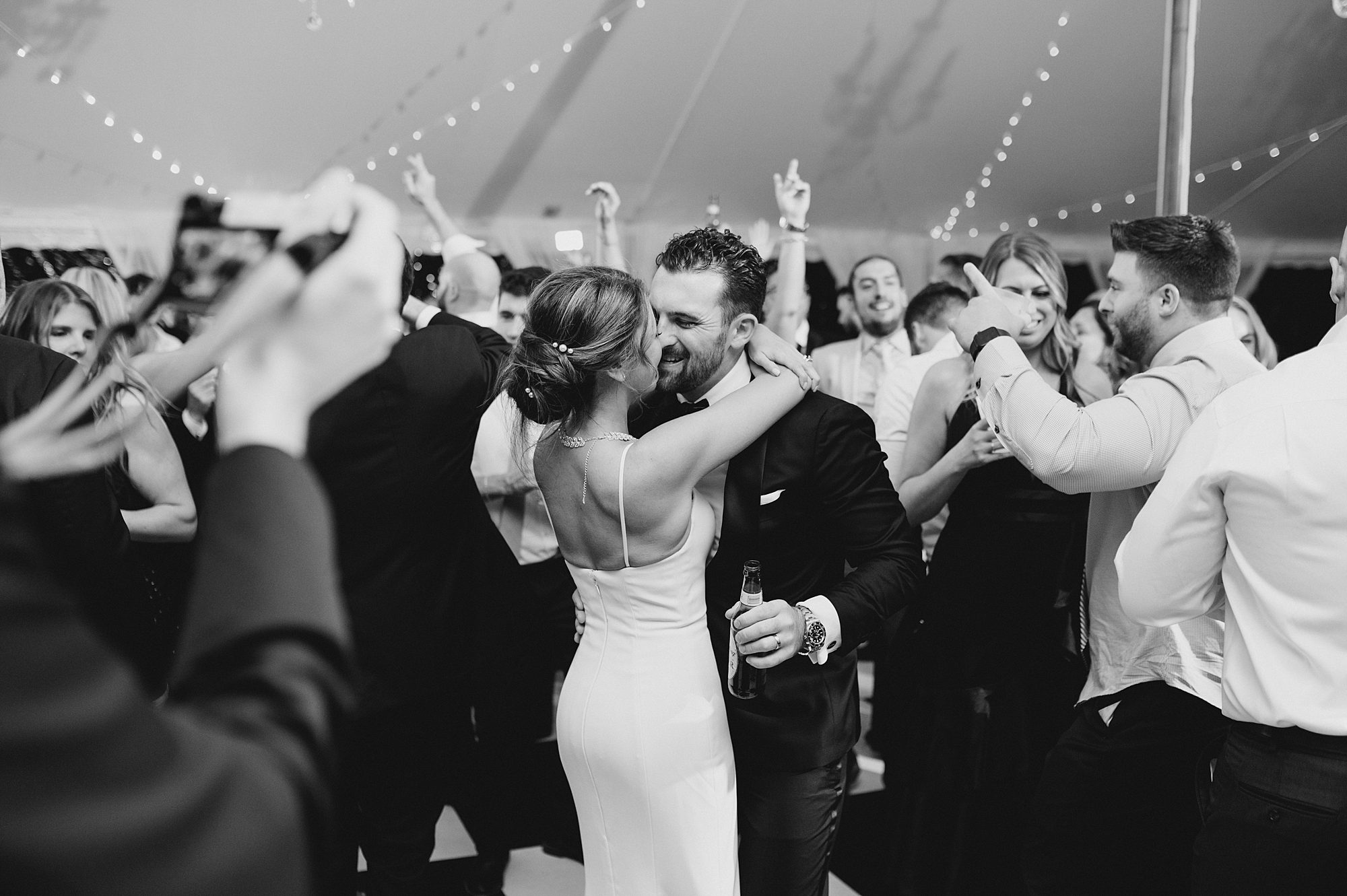 newlyweds dance with guests around them