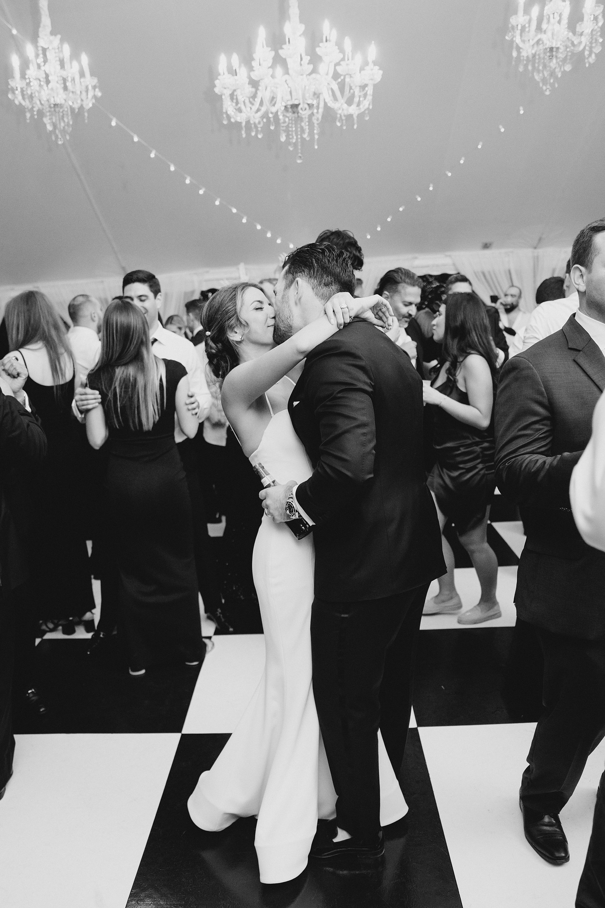 PA Wedding photographer captures couple dancing at wedding reception with guests