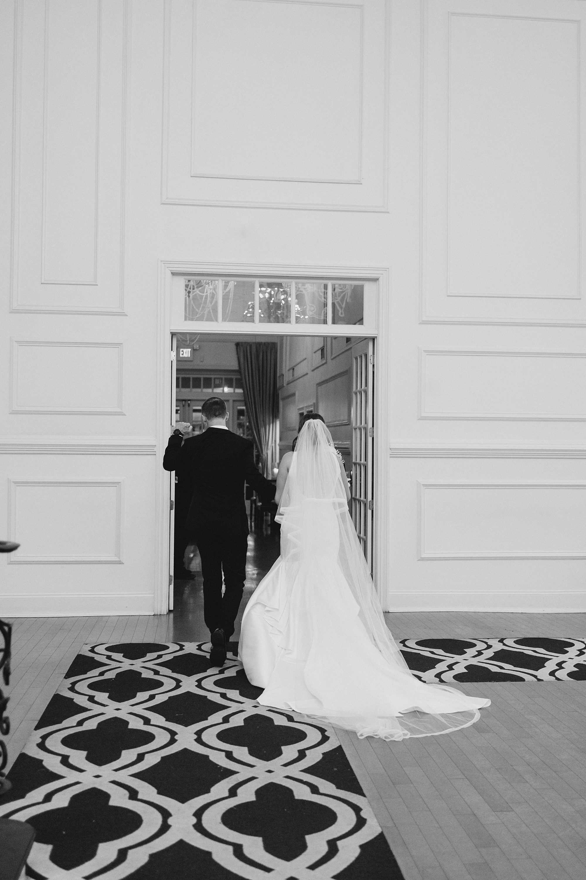 newlyweds walk into Cescaphe Ballroom