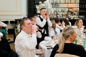 guests laugh during wedding speech