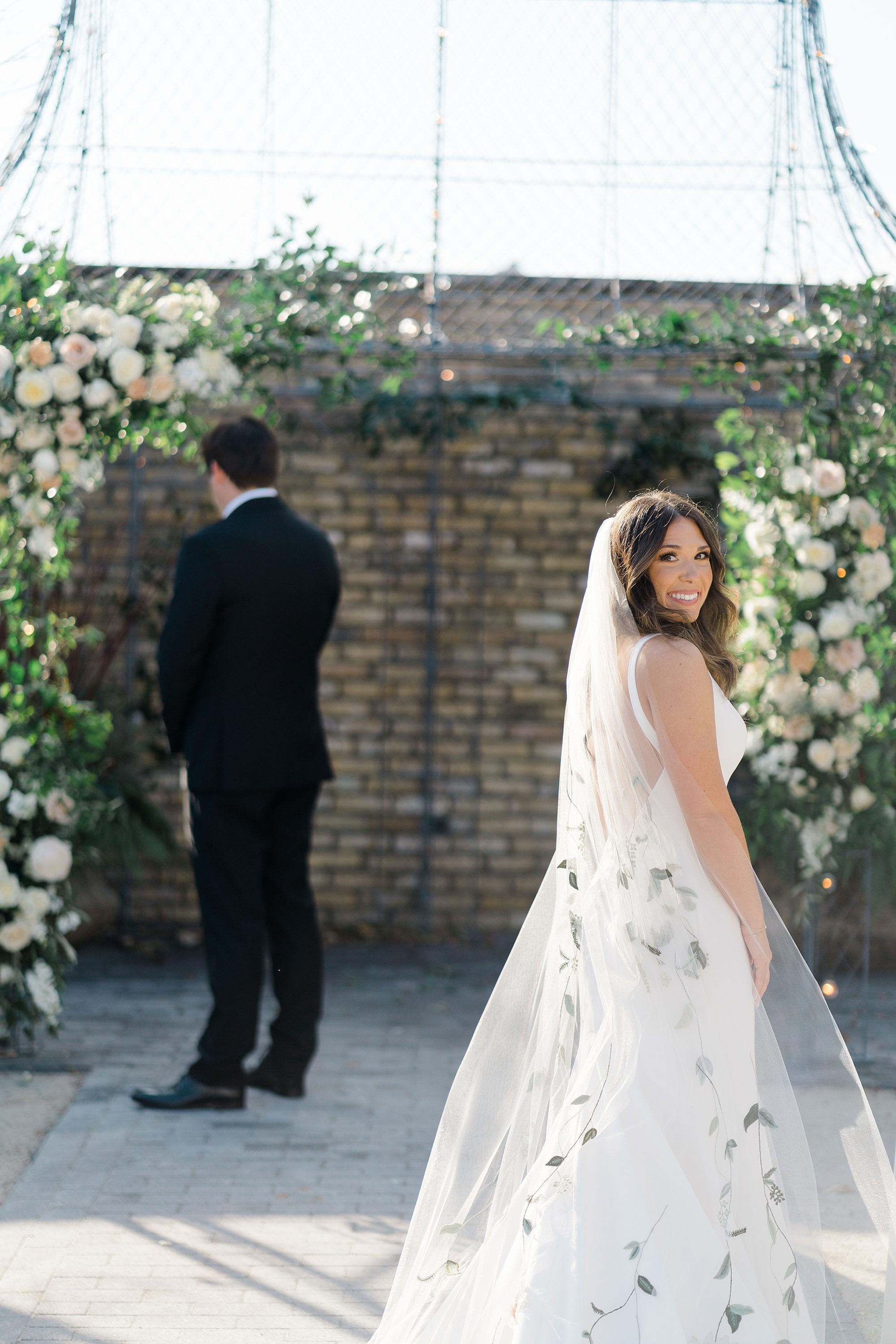 bride in floor length veil with greenery embroidered