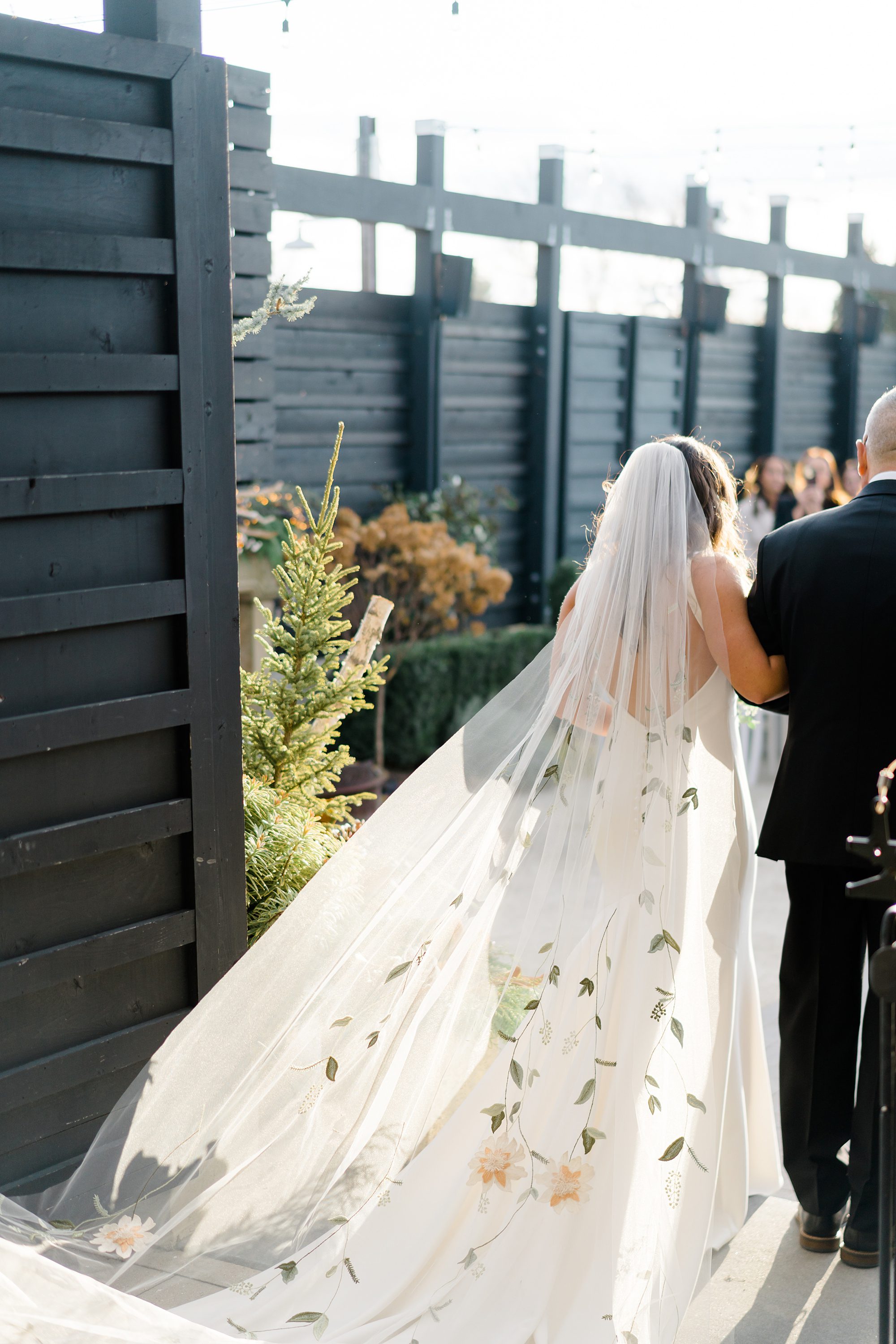 father of the bride walks daughter down the aisle