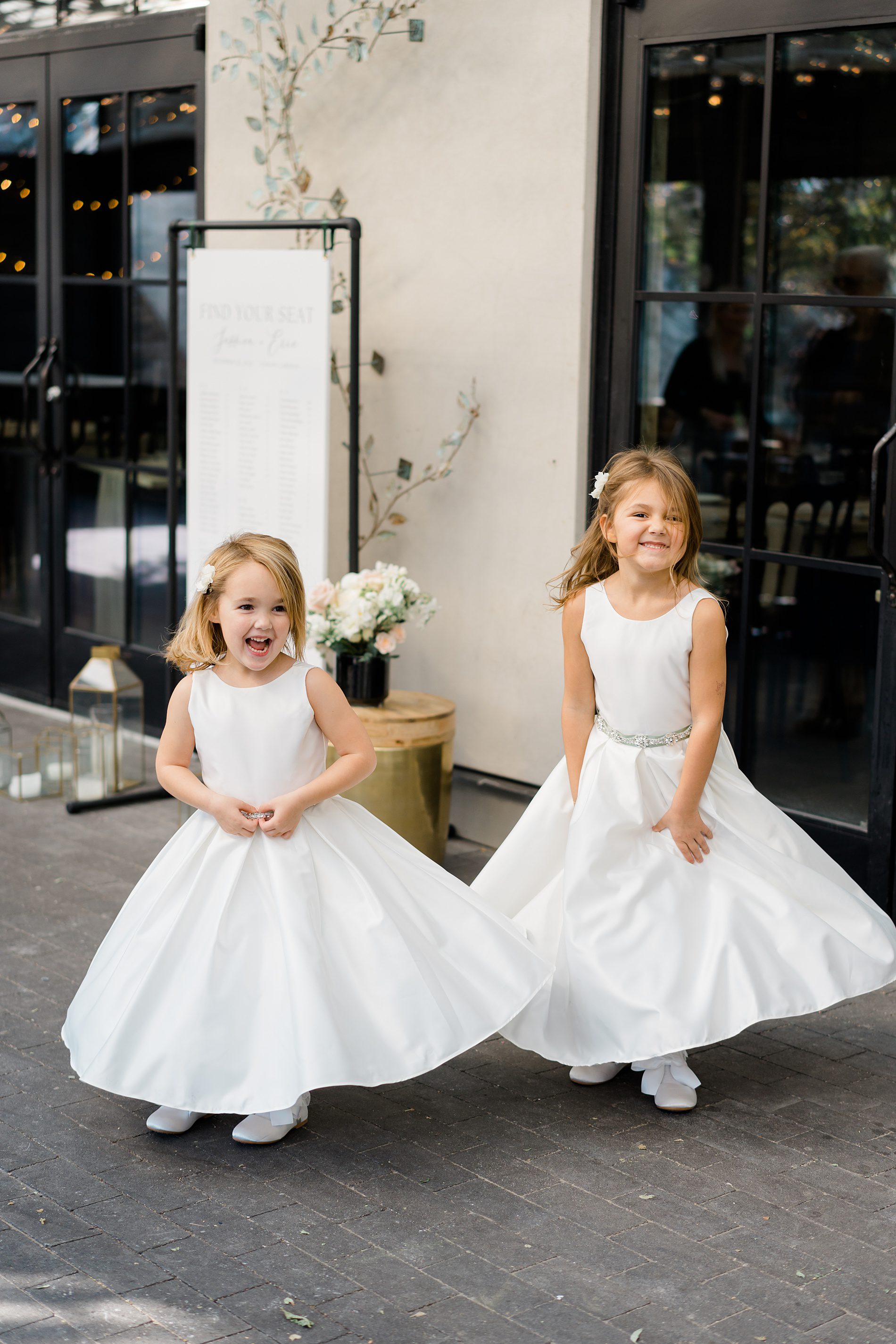 two flower girls twirls in their dresses