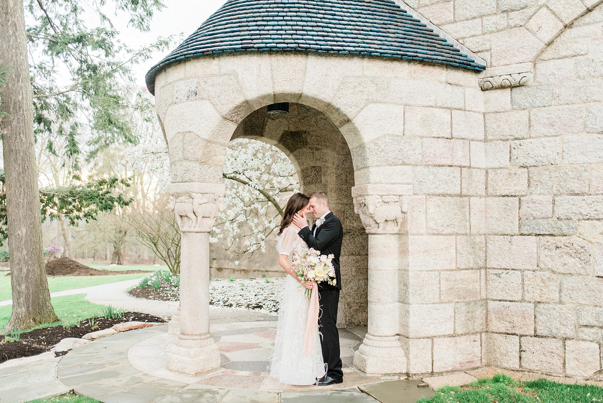 Classic wedding portraits under stone arch 