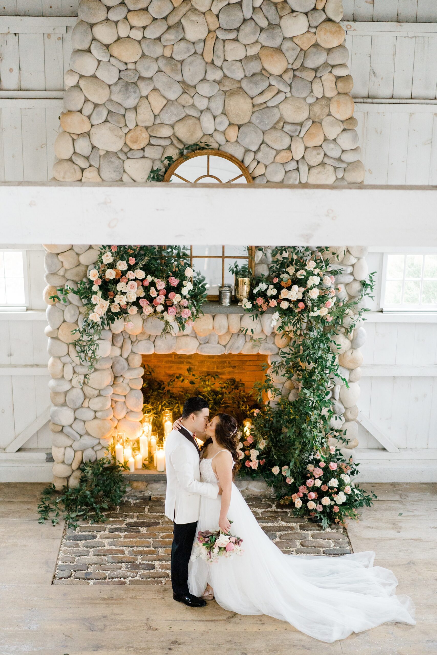 newlyweds kiss by the fireplace
