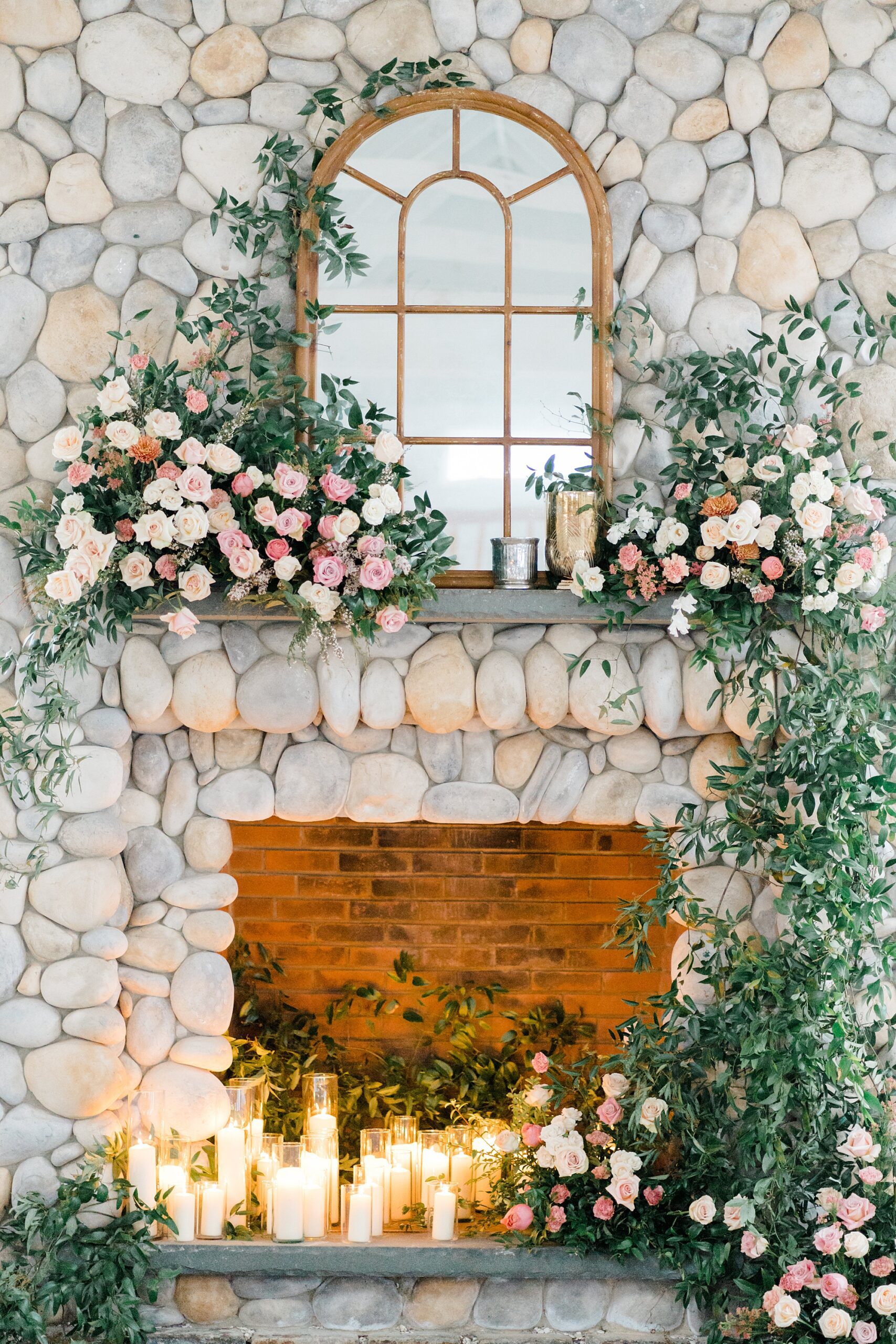 stone fireplace decorated in lush greenery and flowers from Boathouse Chapel at Bonnet Island | Styled Wedding Shoot