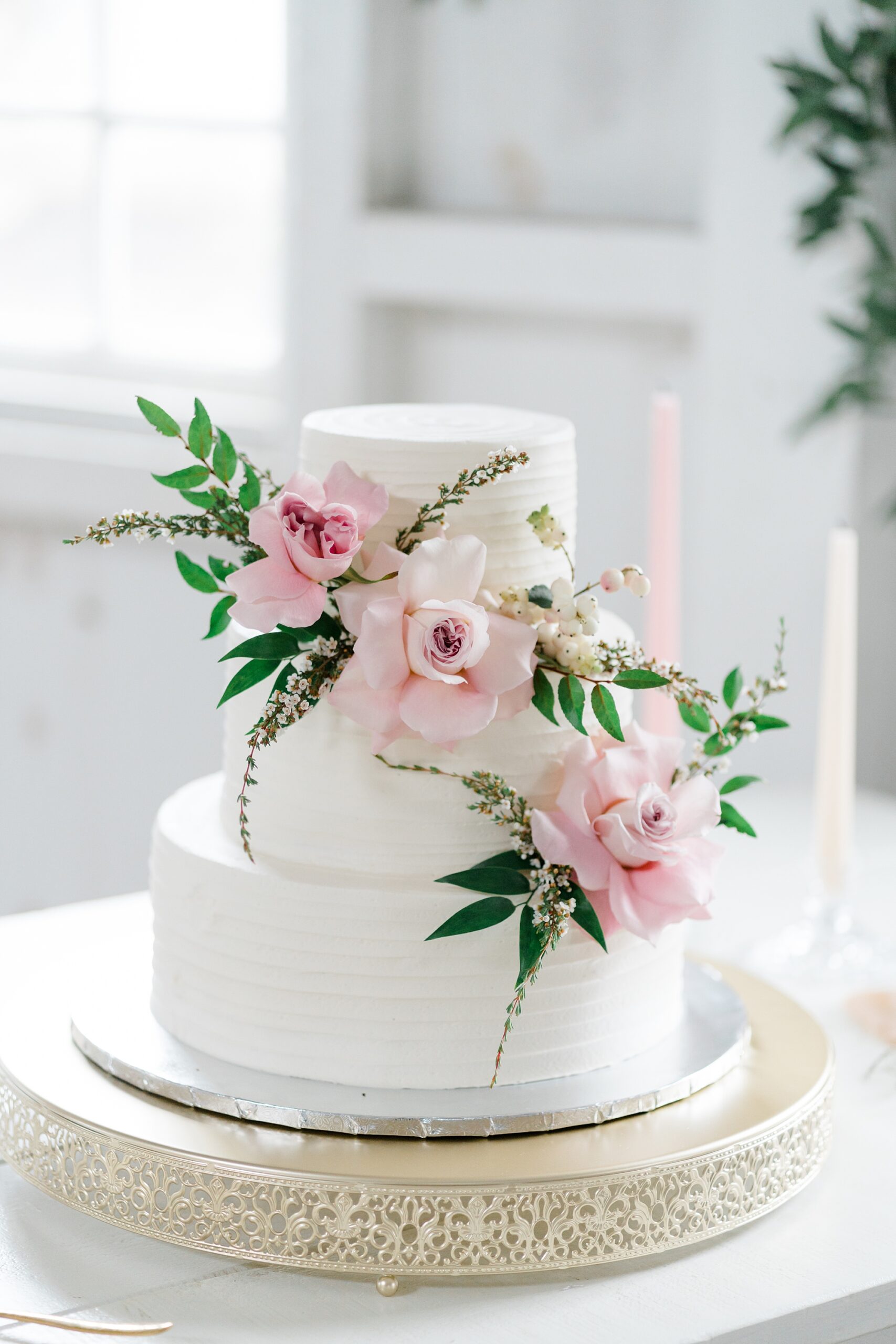 wedding cake with pink flower accents