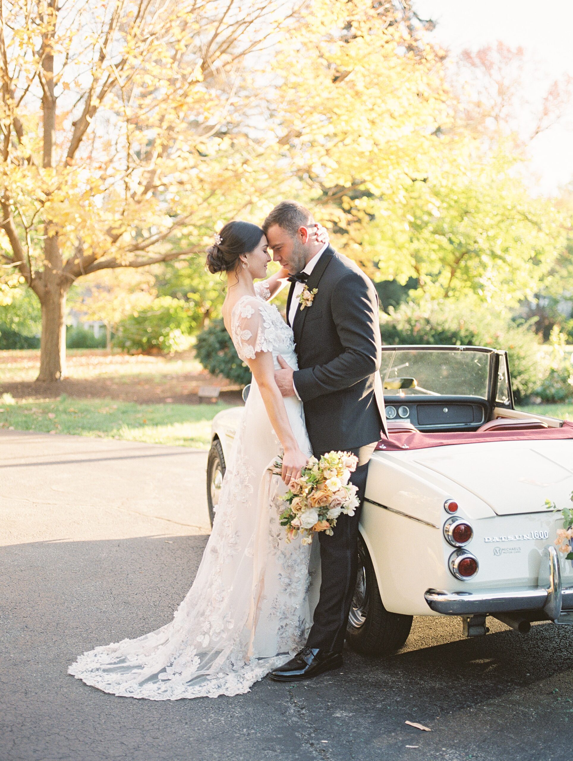 bride and groom by classic car during Pennsylvania wedding at Merion Tribute House 