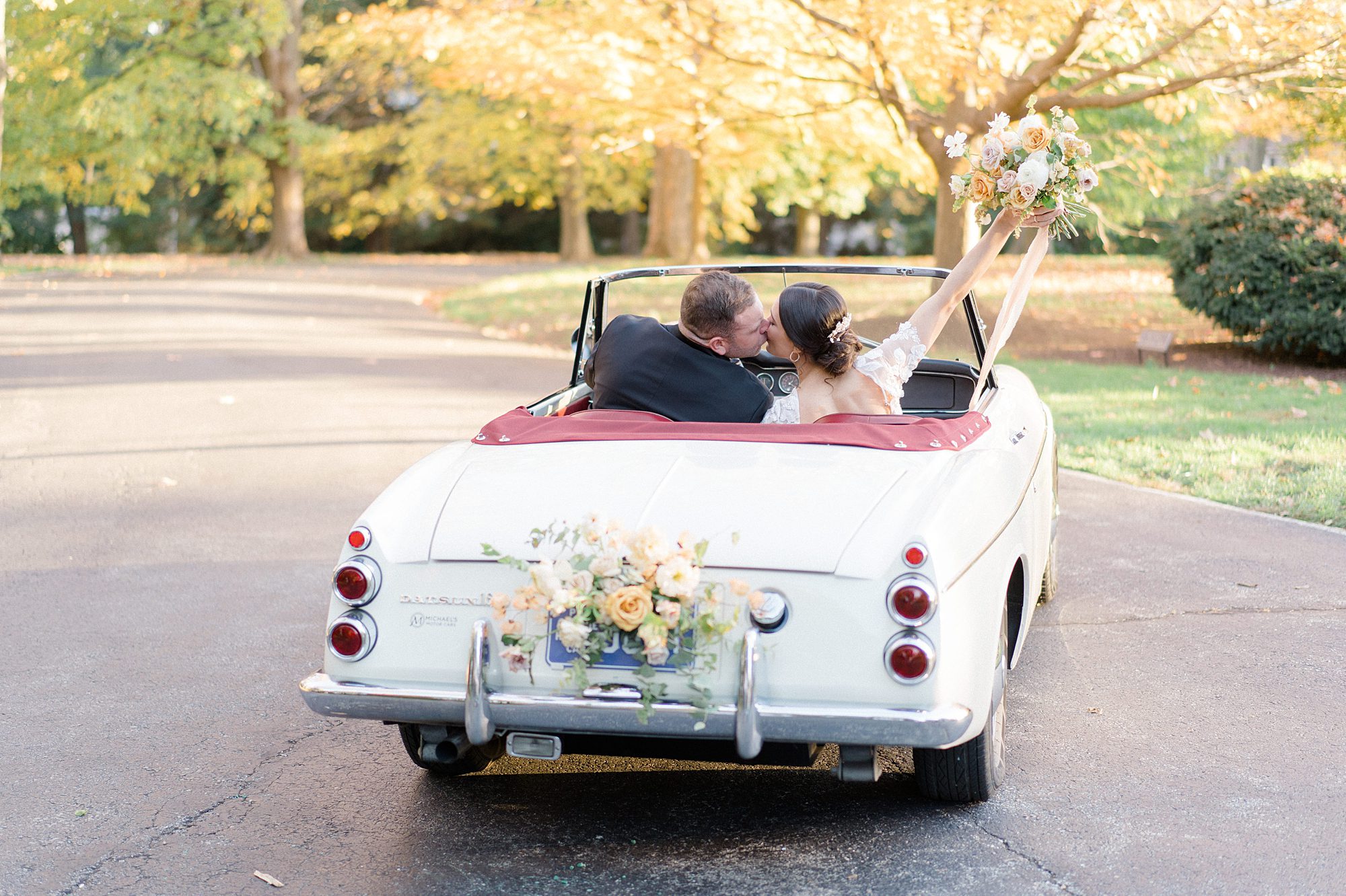 Couple leave wedding in classic car