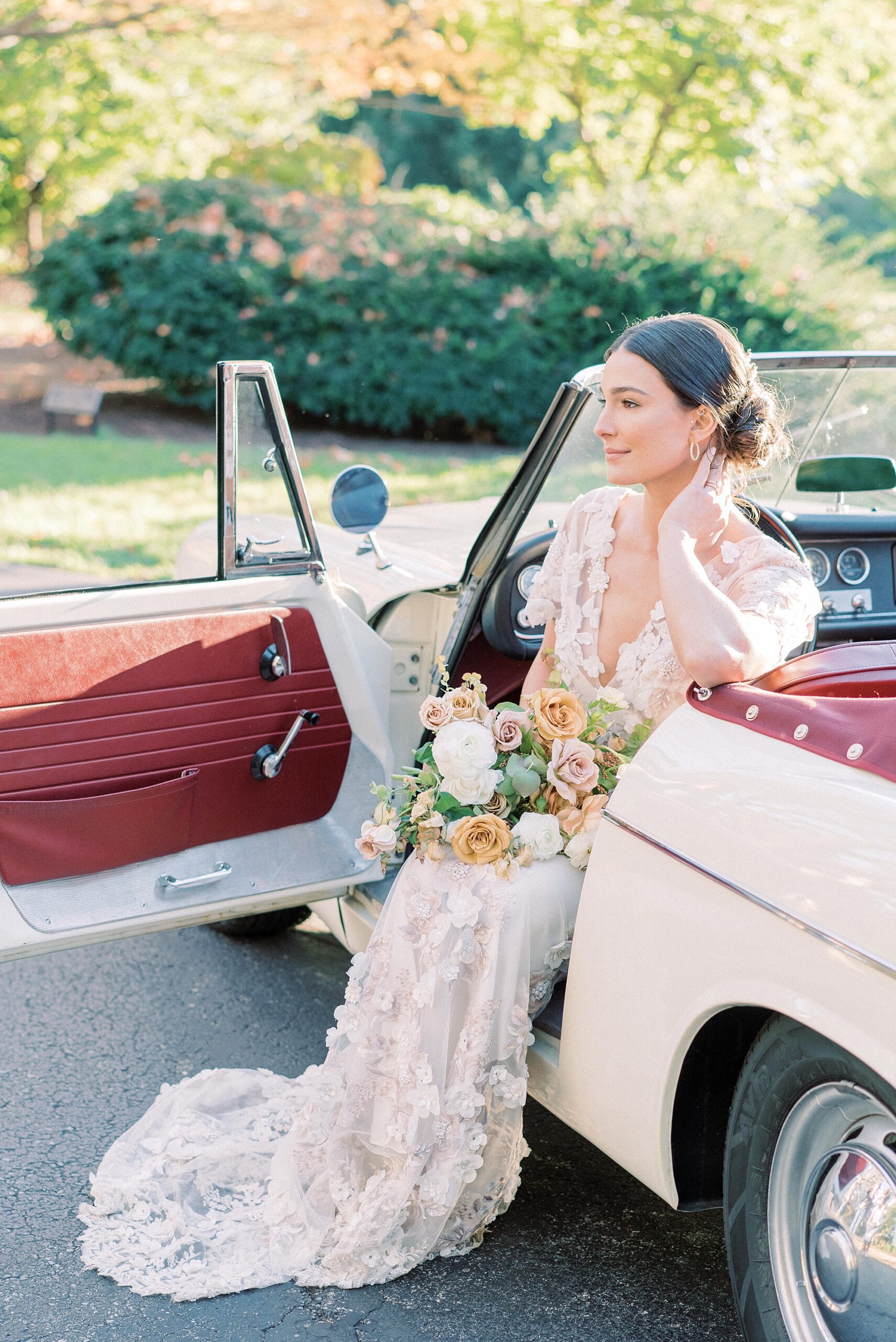 bride sits in classic car 