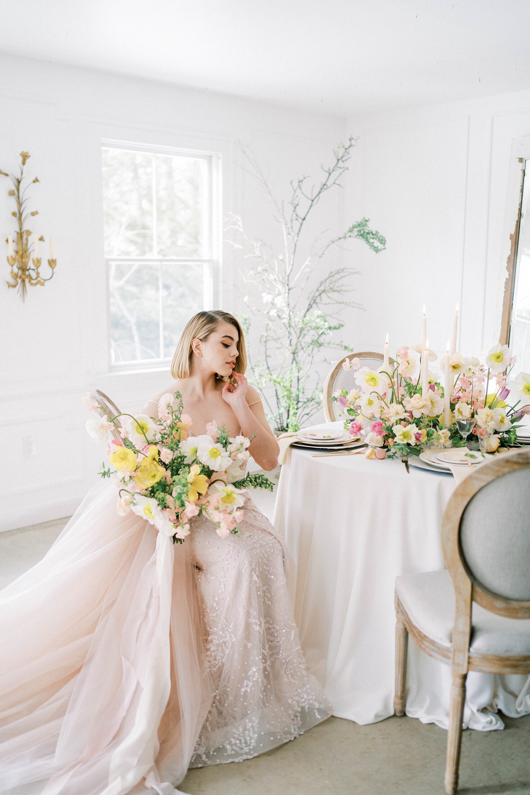 bride sits holding bouquet